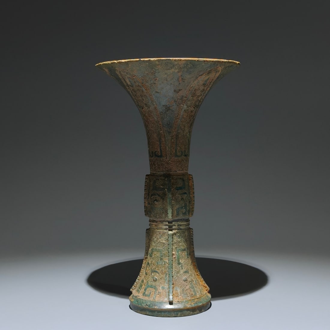 An Archaic Bronze Beast-Face Pattern Libation Cup: An Archaic Bronze Beast-Face Pattern Libation Cup,Shang Dynasty,China,Size:10.6inx6.5in 青铜兽面纹酒杯,中国商代