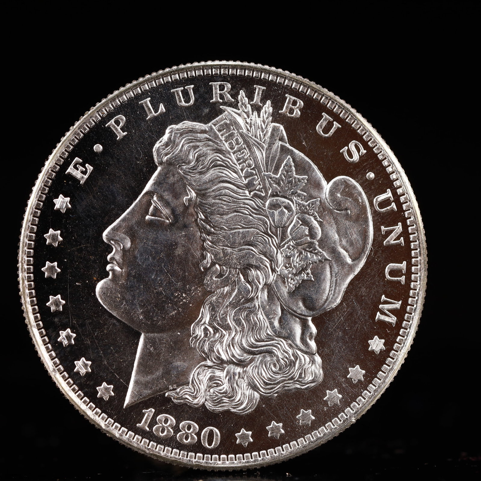 USA Morgan Dollar 1880 Coin: Obv: profile bust with date below and E PLURIBUS UNUM legend and stars around. Rev: eagle with In God we trust above within wreath with UNITED STATES OF AMERICA ONE DOLLAR legend. IN GOD WE TRUST / LI