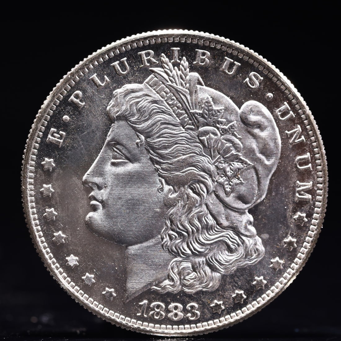 USA Morgan Dollar 1883 Coin: Obv: profile bust with date below and E PLURIBUS UNUM legend and stars around. Rev: eagle with In God we trust above within wreath with UNITED STATES OF AMERICA ONE DOLLAR legend. IN GOD WE TRUST / LI