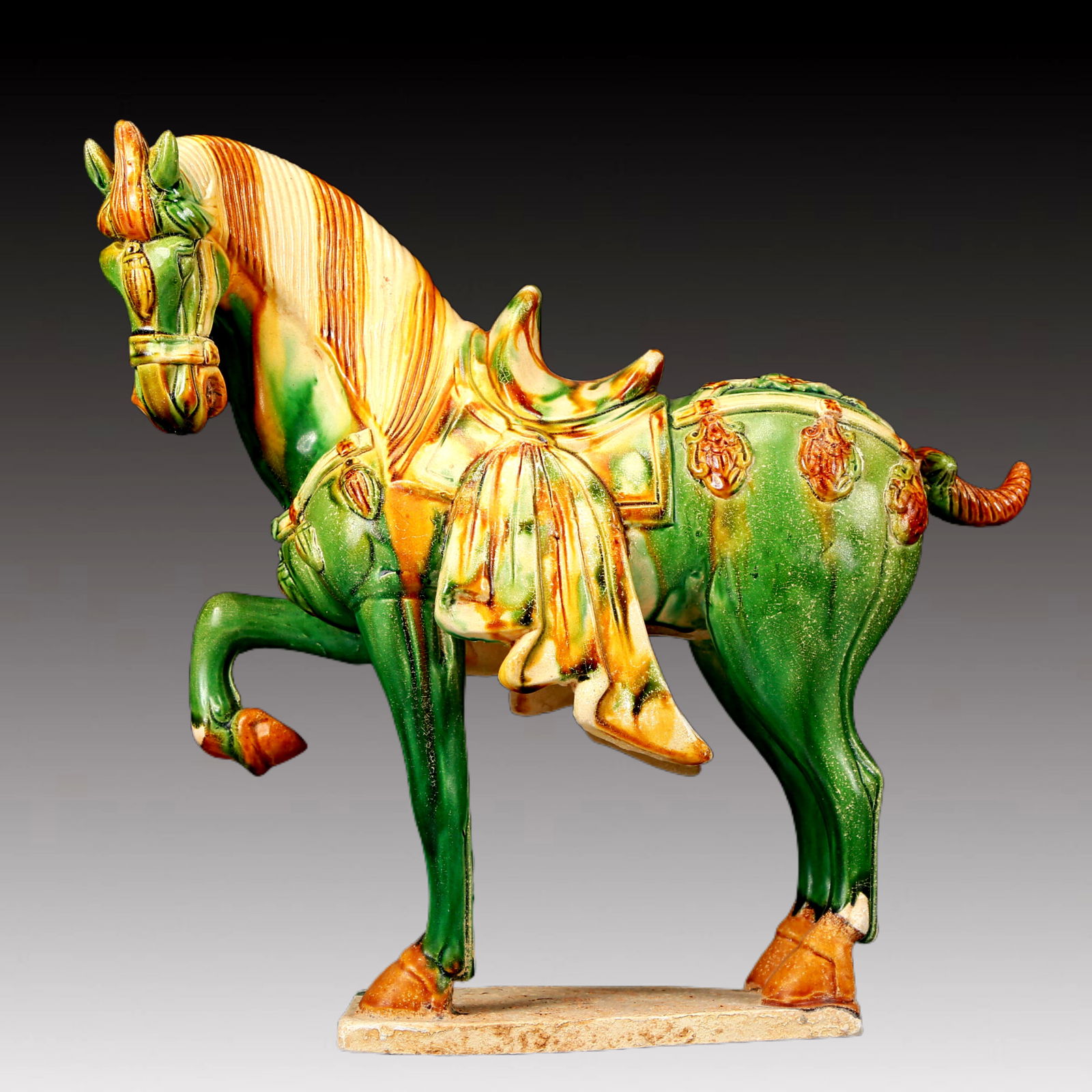 A Rare Tang Tri-Color Glazed Pottery Horse Ornament: A Rare Tang Tri-Color Glazed Pottery Horse Ornament,Tang Dynasty, China,Chinese Tang Tri-colored Pottery, or Tang Sancai, flourished during the Tang Dynasty (618–907 AD). It's renowned for its v