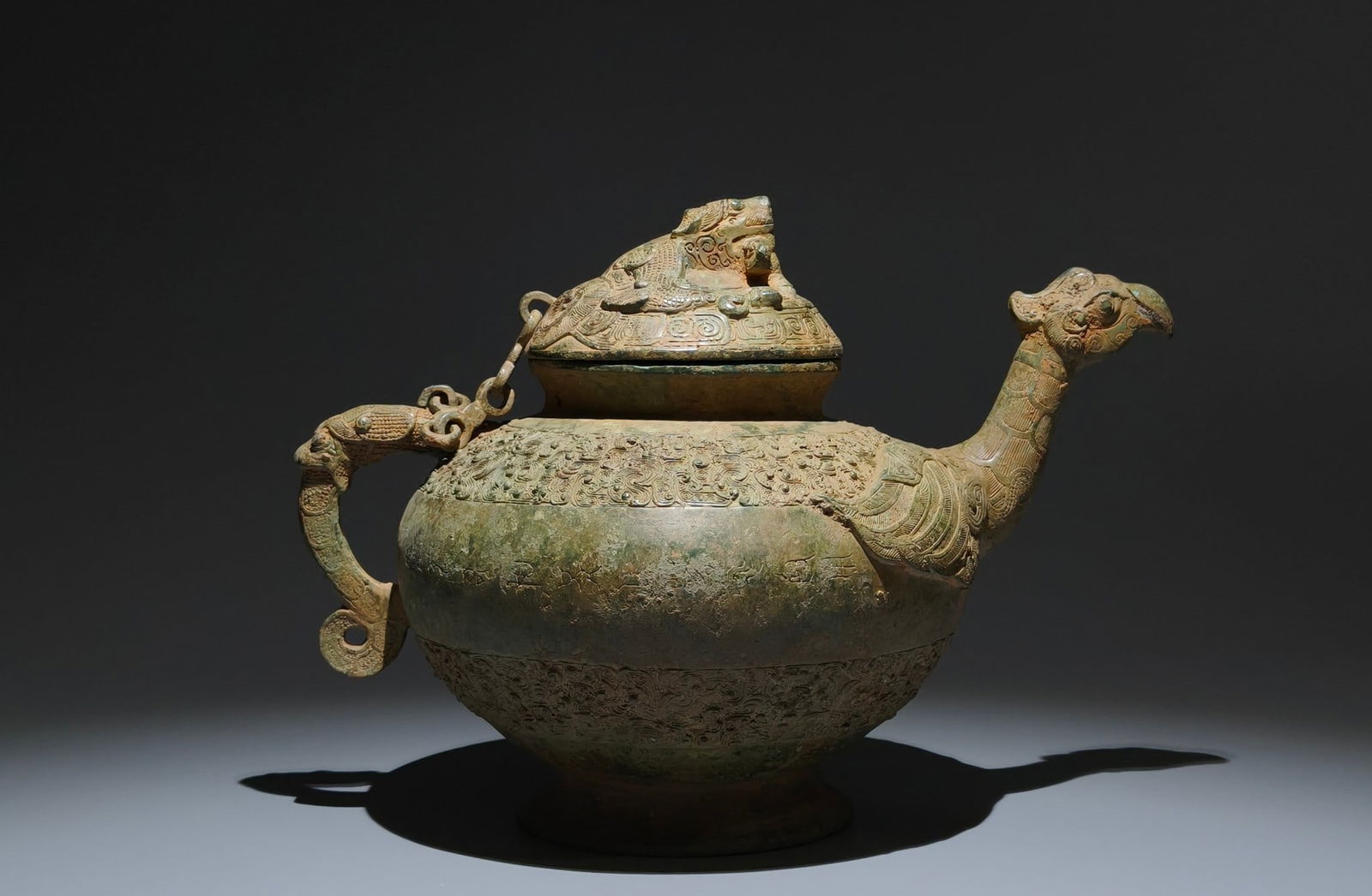 An Archaic Bronze Feather Pattern Bird-head Food Vessel,With Inscription: An Archaic Bronze Feather Pattern Bird-head Food Vessel,With Inscription,the Warring States period in China,Size:9.1inx12.6inx7.9in 青铜羽纹鸟首食器,