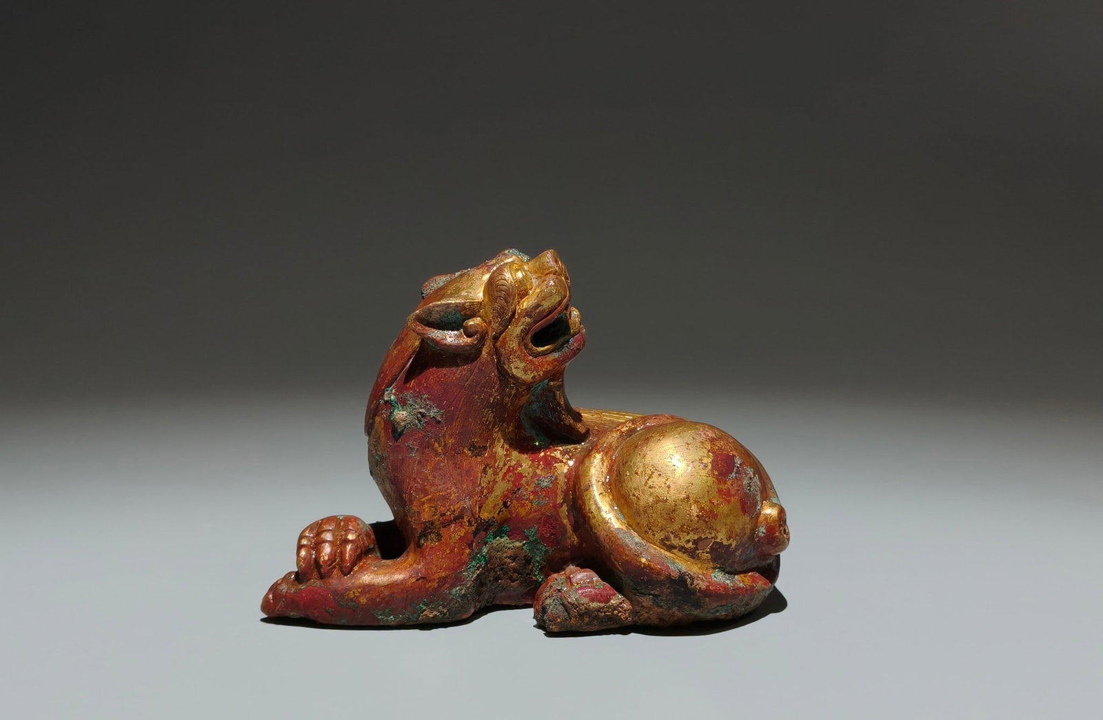 An Exquisite Gilt Bronze Auspicious Beast Ornament: An Exquisite Gilt Bronze Auspicious Beast Ornament,Han Dynasty,China,Size:3.5inx4.9inx2.4in 铜鎏金瑞兽摆件,中国汉代