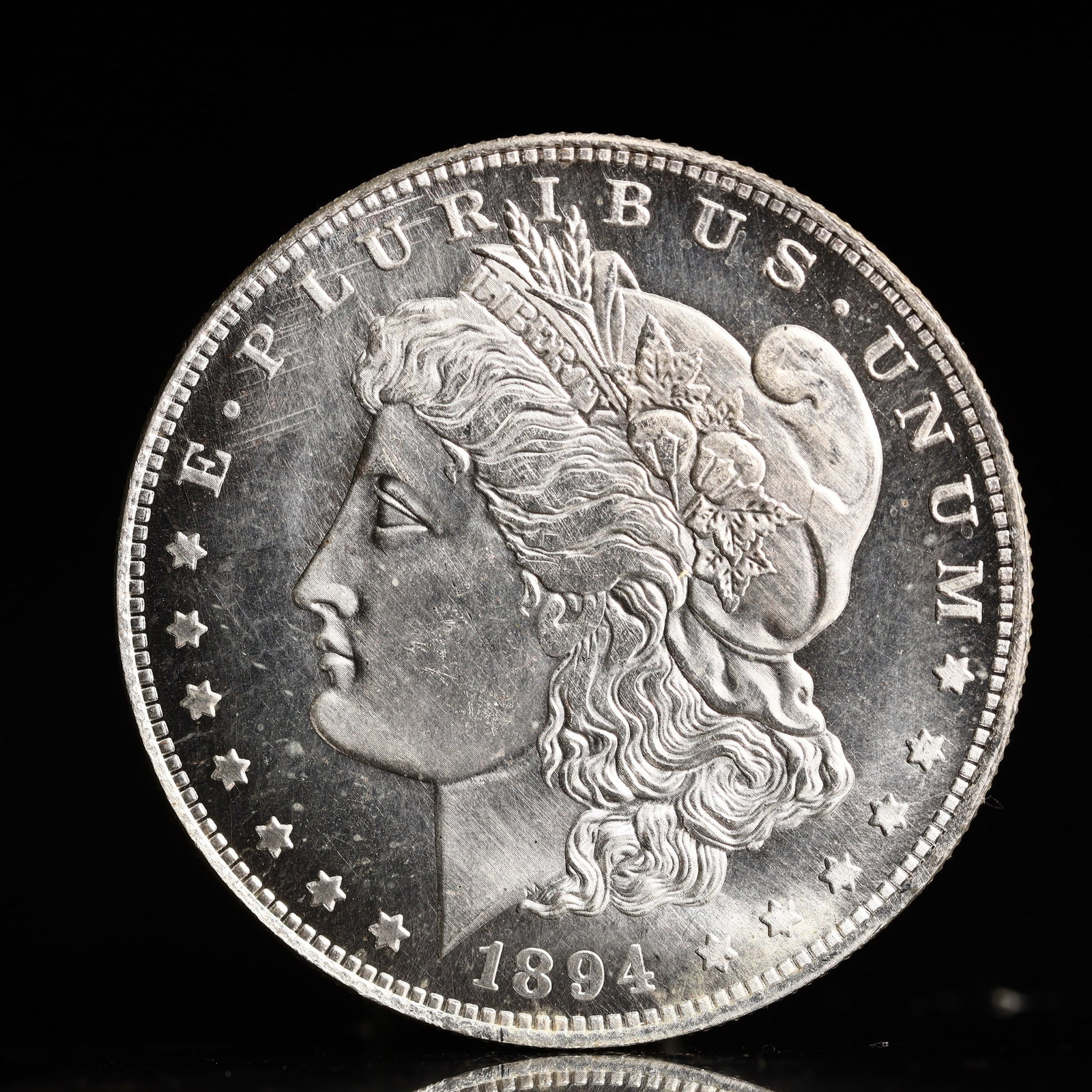 USA Morgan Dollar 1894 Coin: Obv: profile bust with date below and E PLURIBUS UNUM legend and stars around. Rev: eagle with In God we trust above within wreath with UNITED STATES OF AMERICA ONE DOLLAR legend. IN GOD WE TRUST /