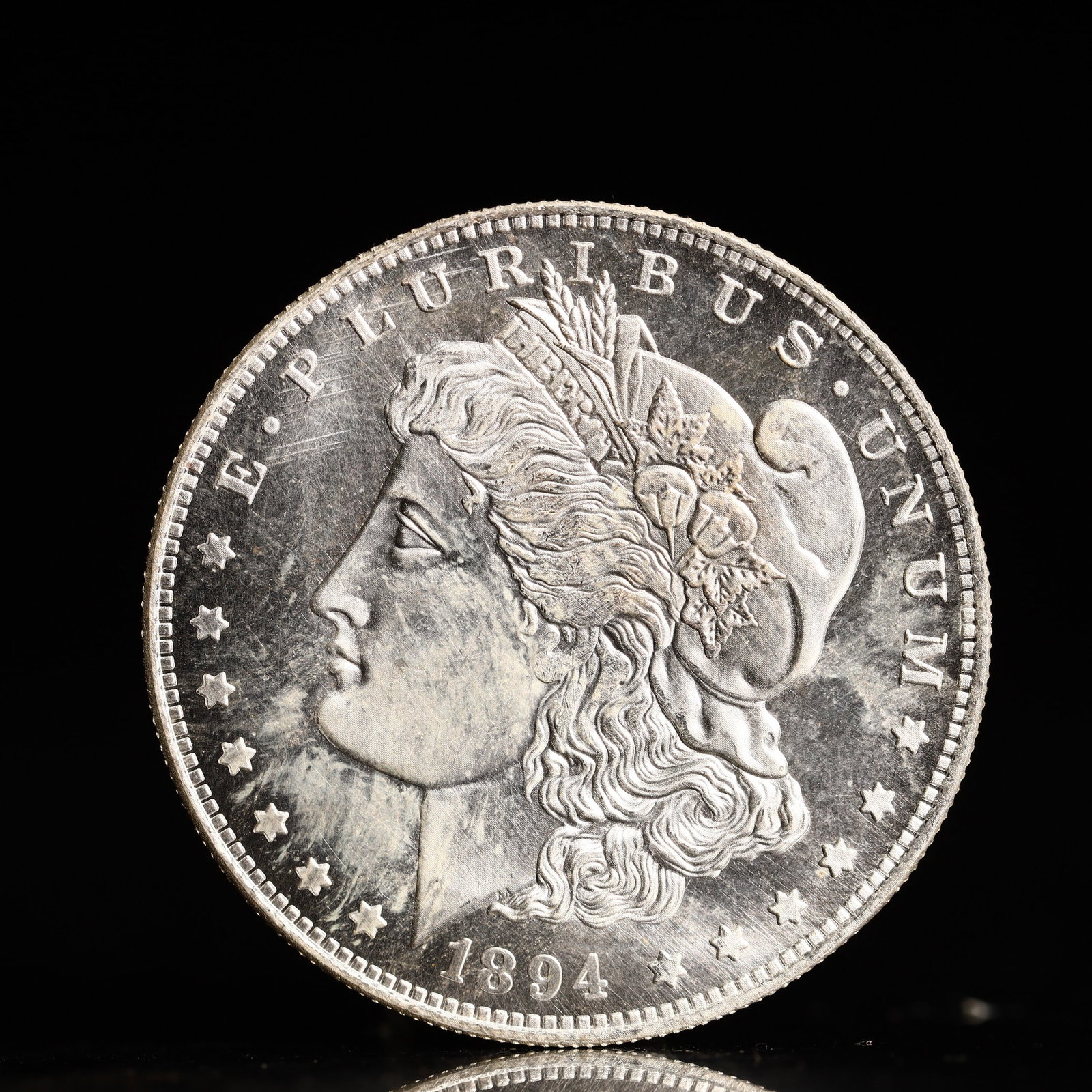 USA Morgan Dollar 1894 Coin: Obv: profile bust with date below and E PLURIBUS UNUM legend and stars around. Rev: eagle with In God we trust above within wreath with UNITED STATES OF AMERICA ONE DOLLAR legend. IN GOD WE TRUST / LI
