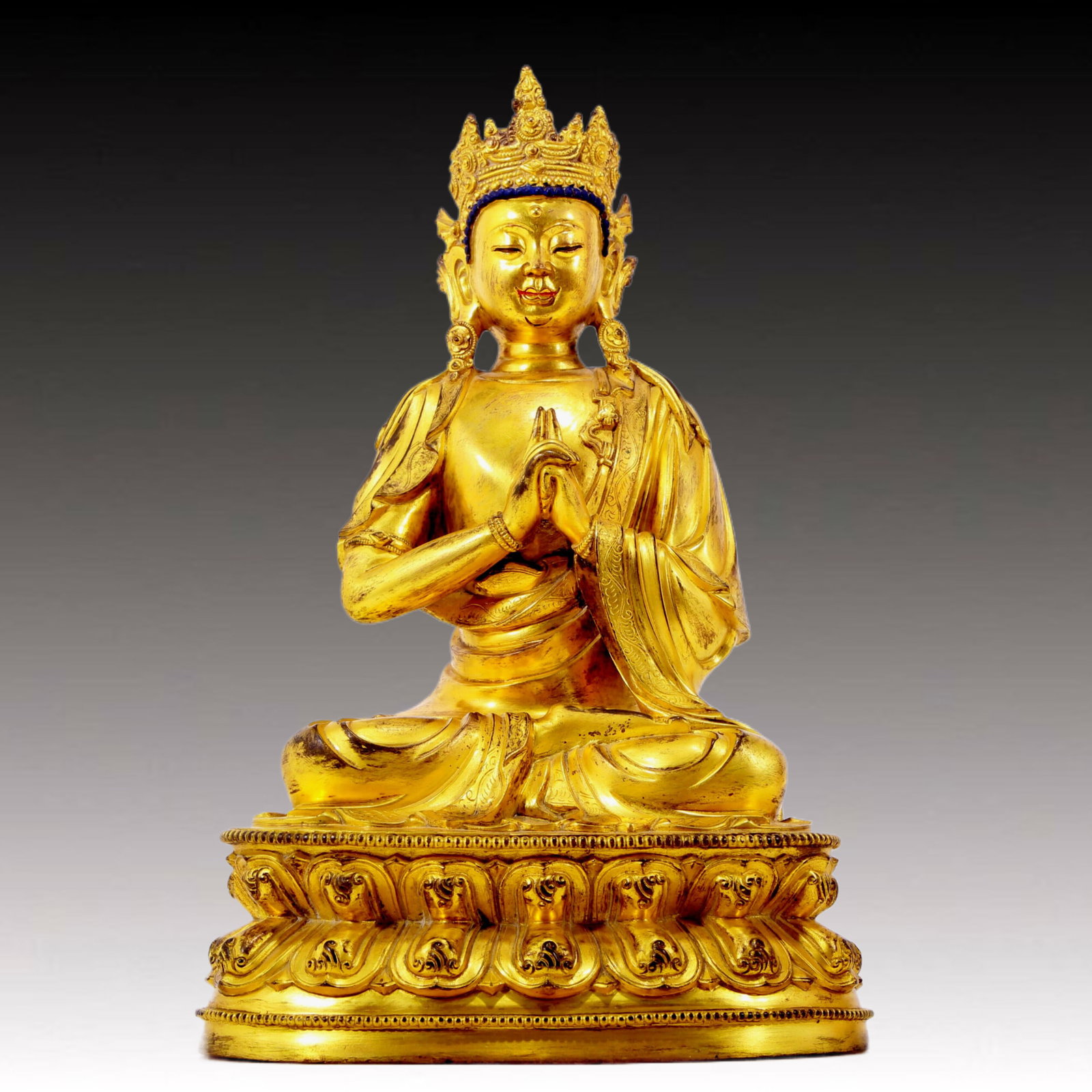 A solemn gilt bronze statue of Bodhisattva: A solemn gilt bronze Bodhisattva statue, Qing Dynasty, China, The Bodhisattva's posture is graceful and peaceful, embodying compassion and wisdom. The sculptures are richly decorated, such as ornate