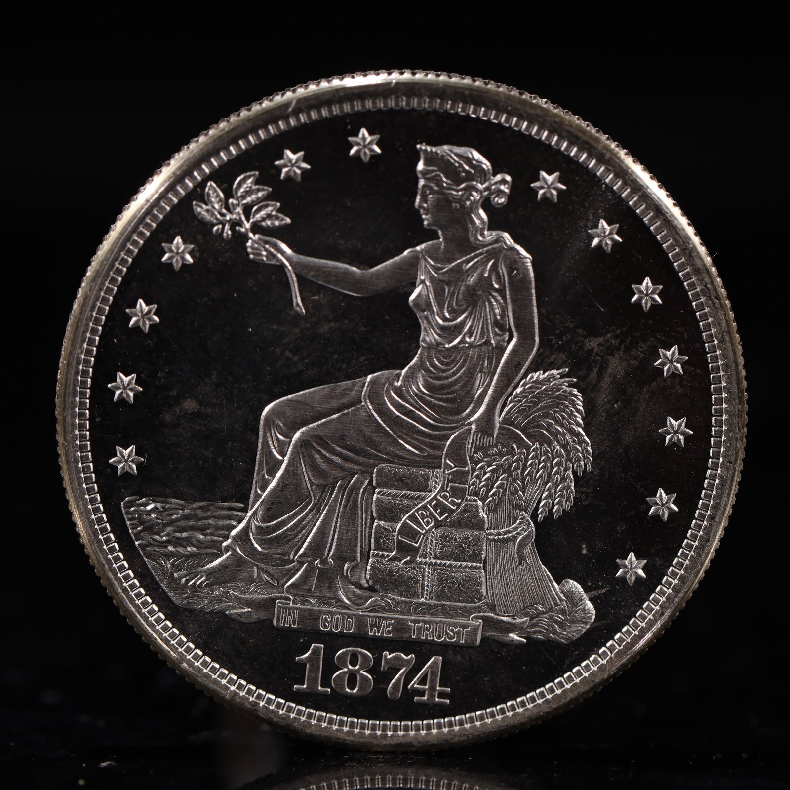 USA Trade Dollar 1874 Coin: American coin. Obverse: Liberty seated on a pedestal facing the sea to the left holding olive branches surrounded by 13 stars. IN GOD WE TRUST / LIBERTY / 1874. Reverse: An eagle holding branches with