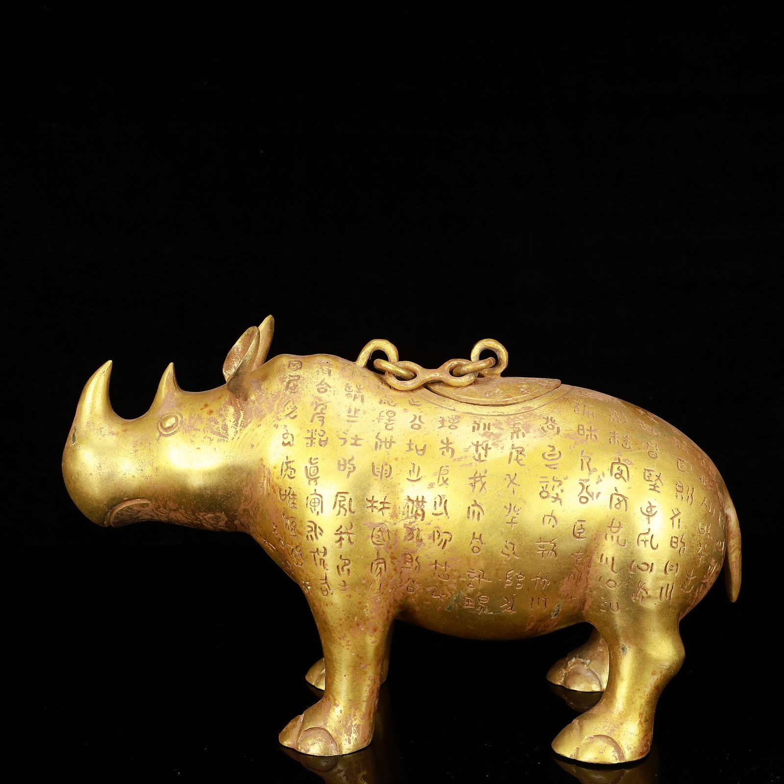A Rare Gilt Bronze Rhinoceros Zun,With Inscription: A Rare Gilt Bronze Rhinoceros Zun,With Inscription,The Warring States period in China,Size:12.6inx4.7inx7.9in,Weight:2650g 