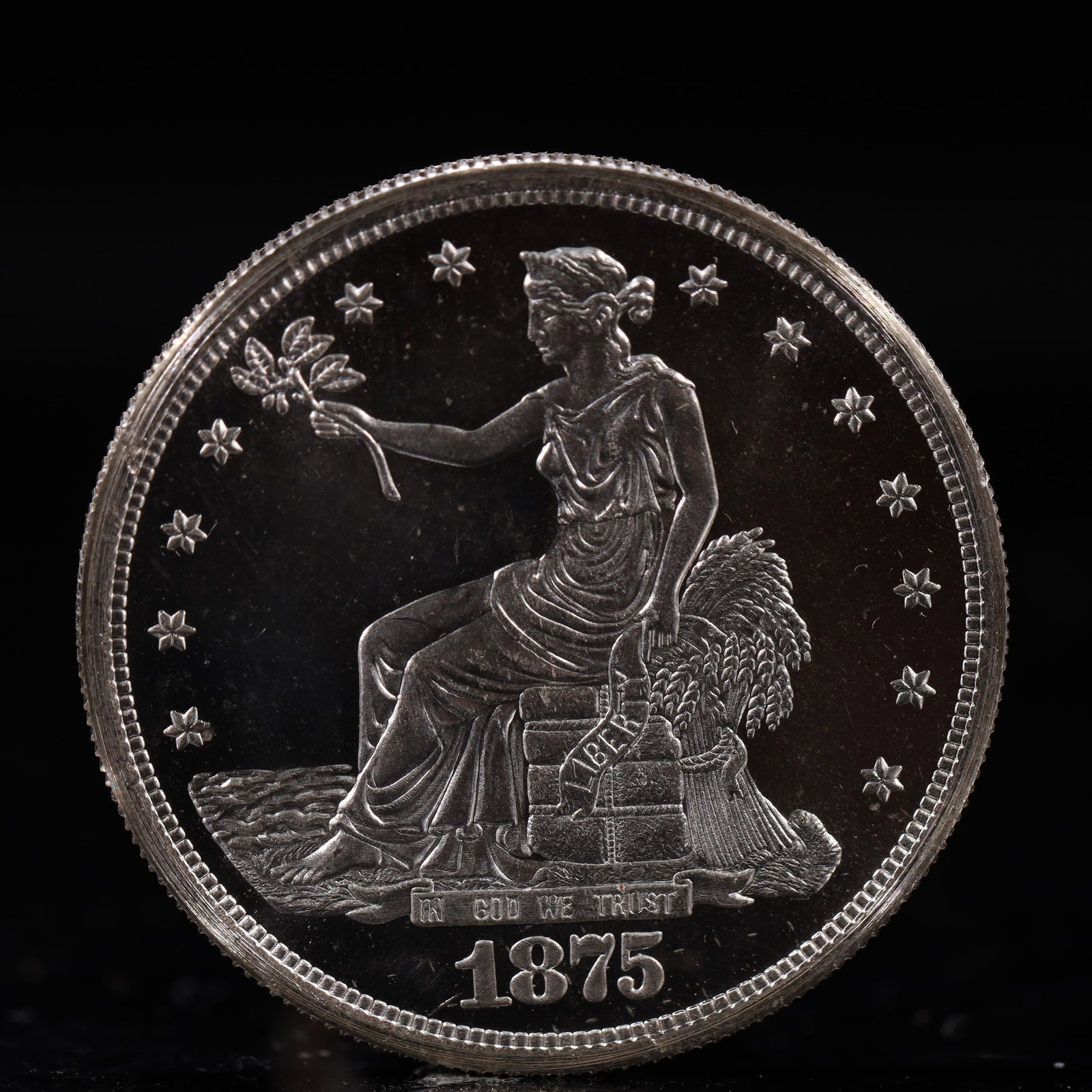 USA Trade Dollar 1875 Coin: American coin. Obverse: Liberty seated on a pedestal facing the sea to the left holding olive branches surrounded by 13 stars. IN GOD WE TRUST / LIBERTY / 1875. Reverse: An eagle holding branches