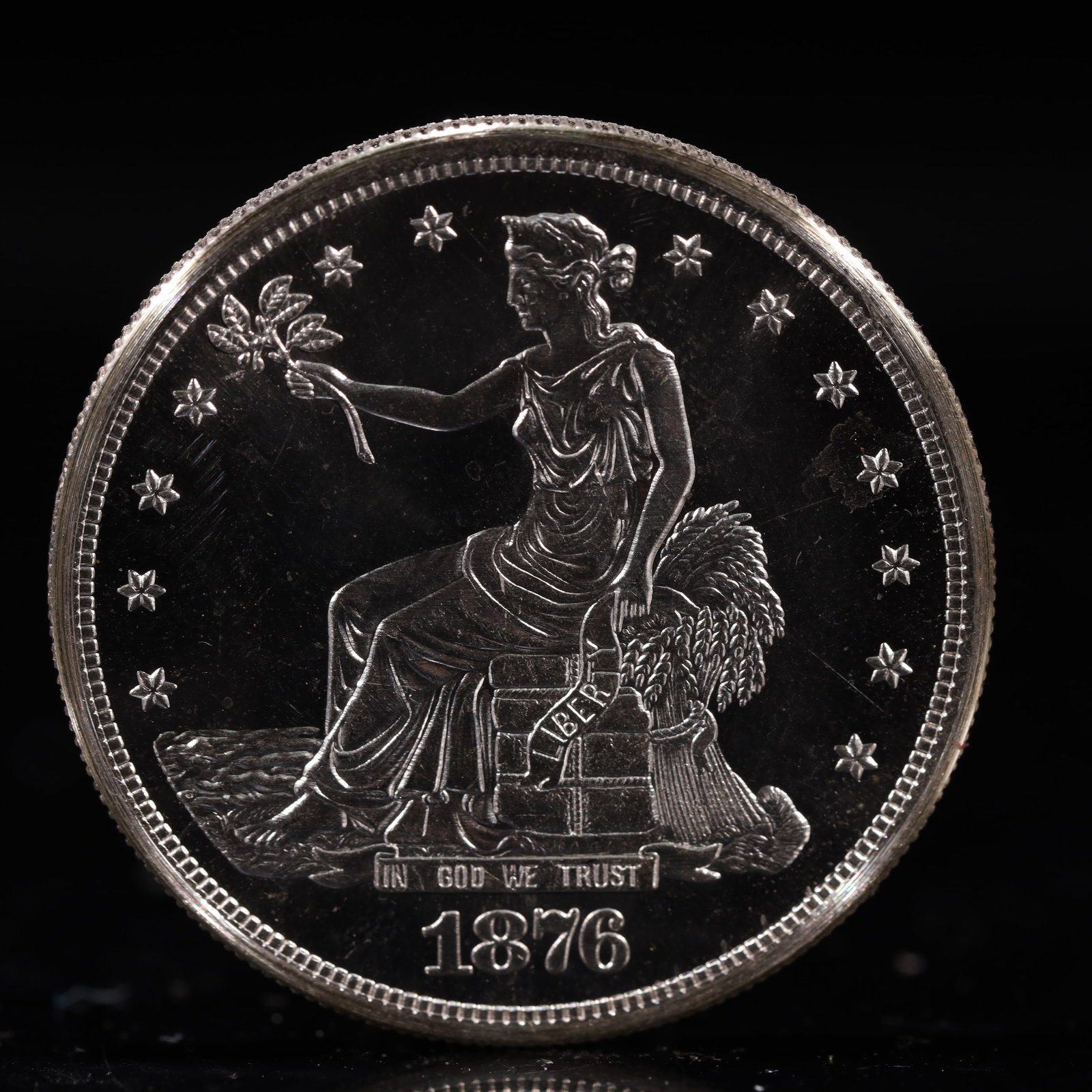 USA Trade Dollar 1876 Coin: American coin. Obverse: Liberty seated on a pedestal facing the sea to the left holding olive branches surrounded by 13 stars. IN GOD WE TRUST / LIBERTY / 1876. Reverse: An eagle holding branches with