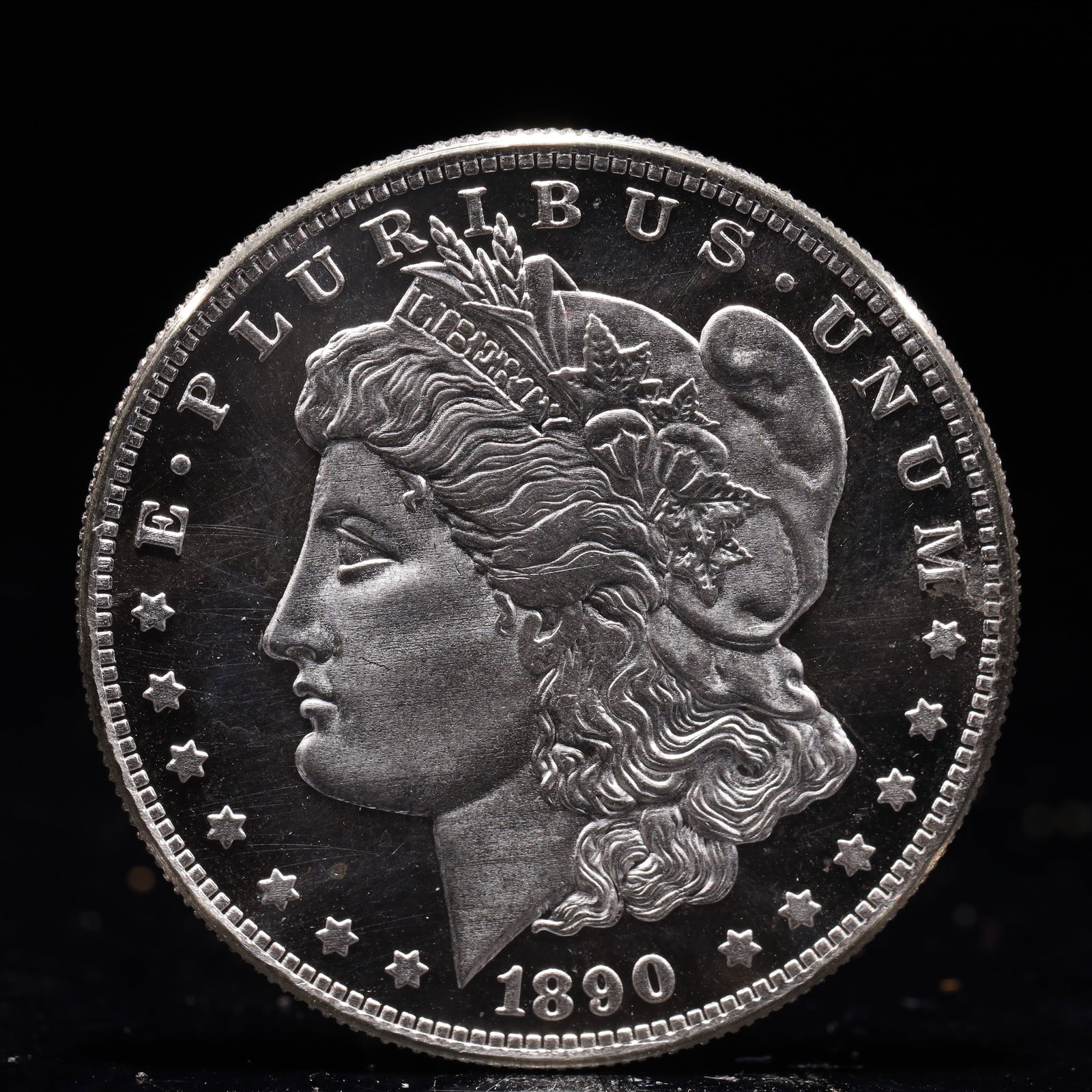 USA Morgan Dollar 1890 Coin: Obv: profile bust with date below and E PLURIBUS UNUM legend and stars around. Rev: eagle with In God we trust above within wreath with UNITED STATES OF AMERICA ONE DOLLAR legend. IN GOD WE TRUST /