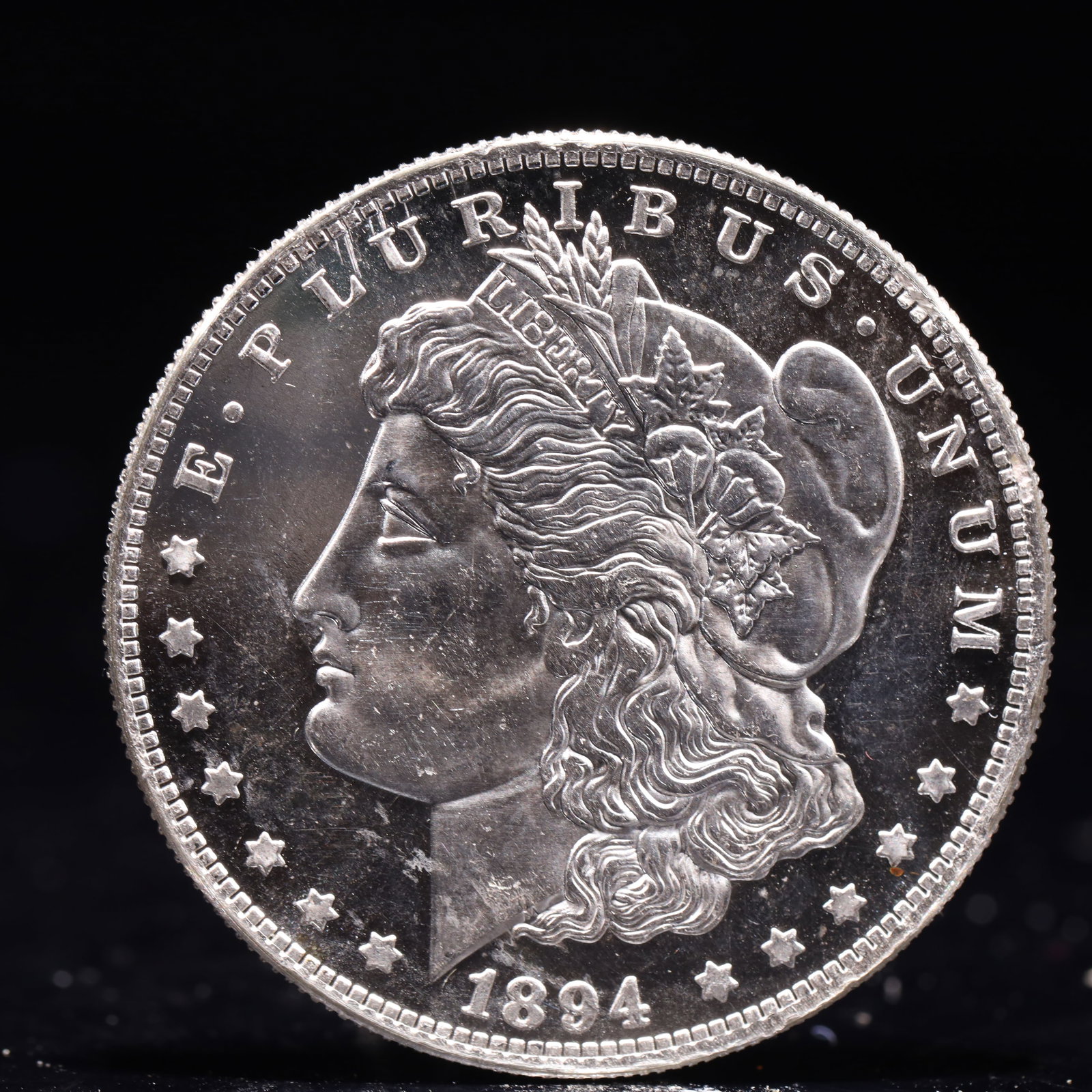 USA Morgan Dollar 1894 Coin: Obv: profile bust with date below and E PLURIBUS UNUM legend and stars around. Rev: eagle with In God we trust above within wreath with UNITED STATES OF AMERICA ONE DOLLAR legend. IN GOD WE TRUST /
