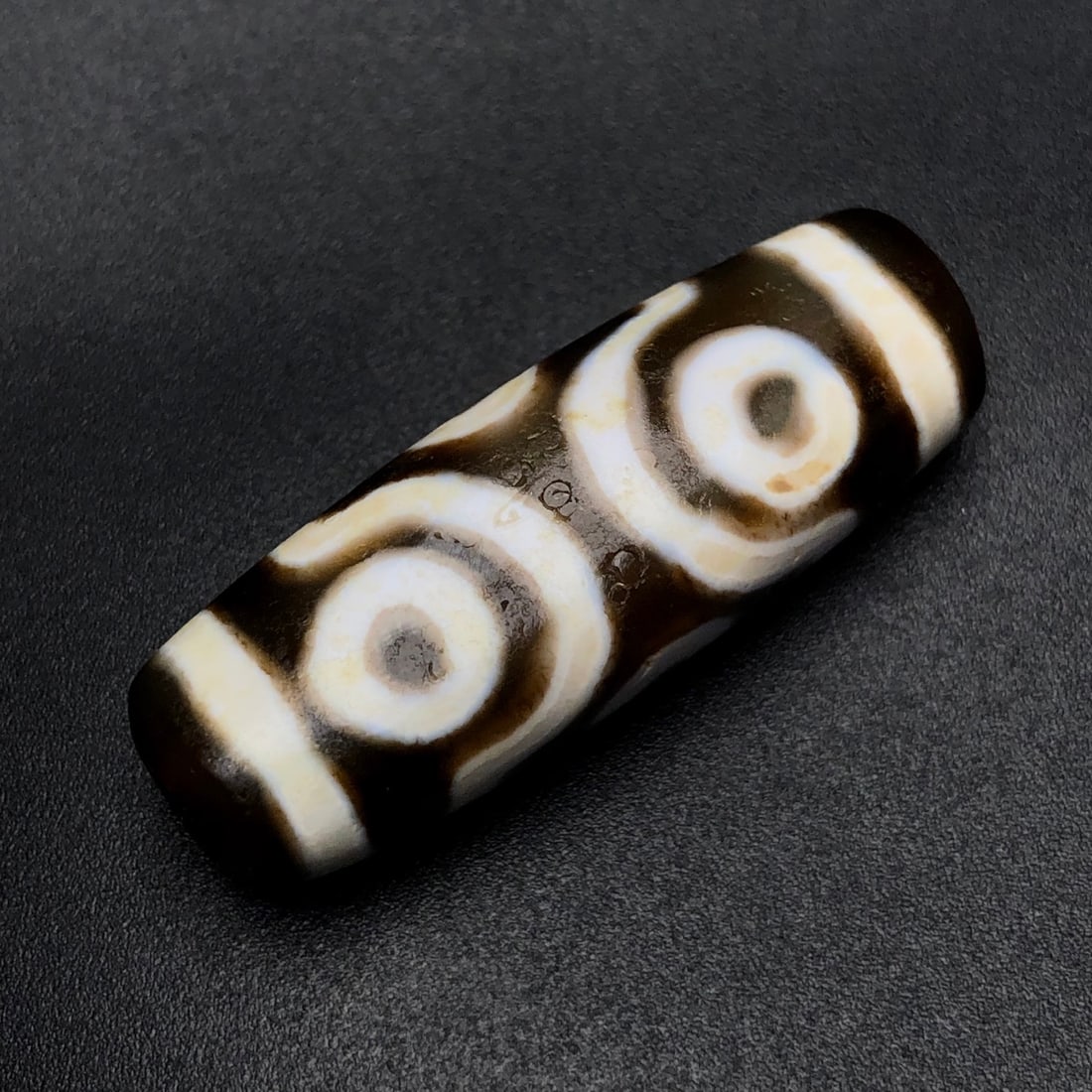 An Exquisite Six Eyes Dzi Bead Pendant: An Exquisite Six Eyes Dzi Bead Pendant,Size:36mmx12mmx10mm,Weight:7.4g 六眼天珠挂件