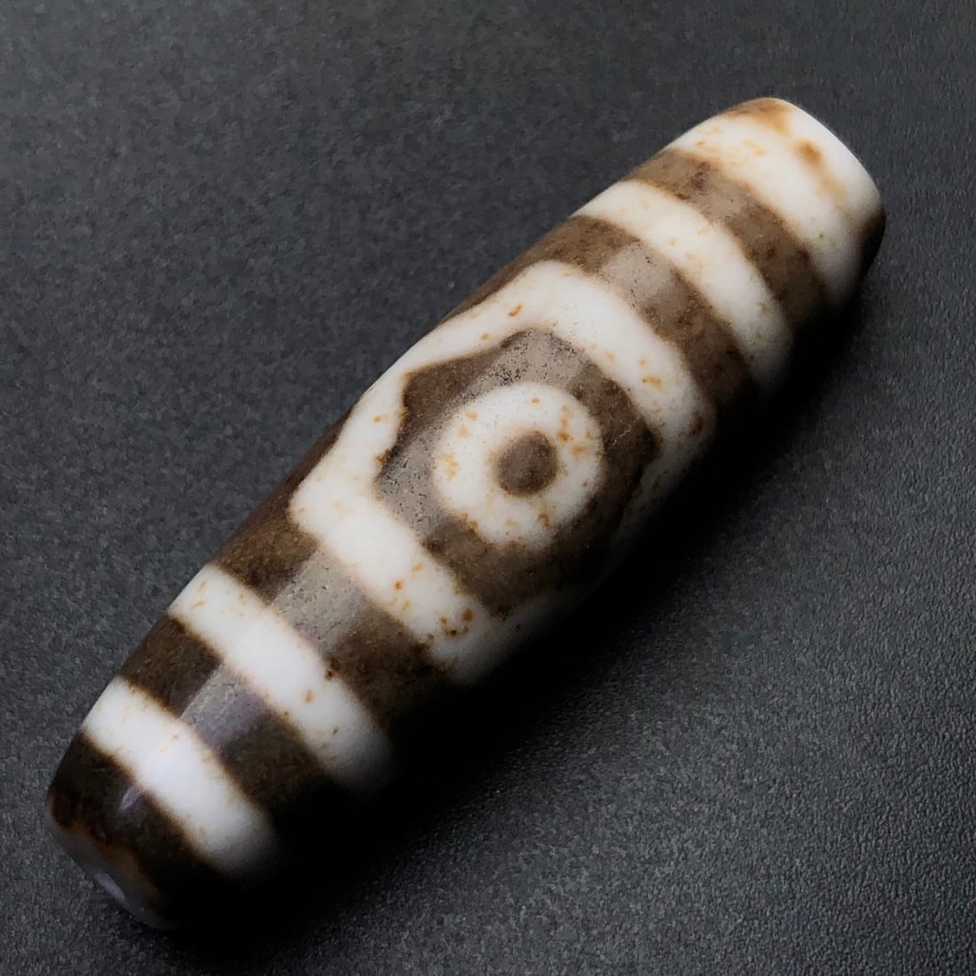 An Exquisite Three Eyes Dzi Bead Pendant: An Exquisite Three Eyes Dzi Bead Pendant,Size:43mmx12mm,Weight:9.9g 三眼天珠挂件
