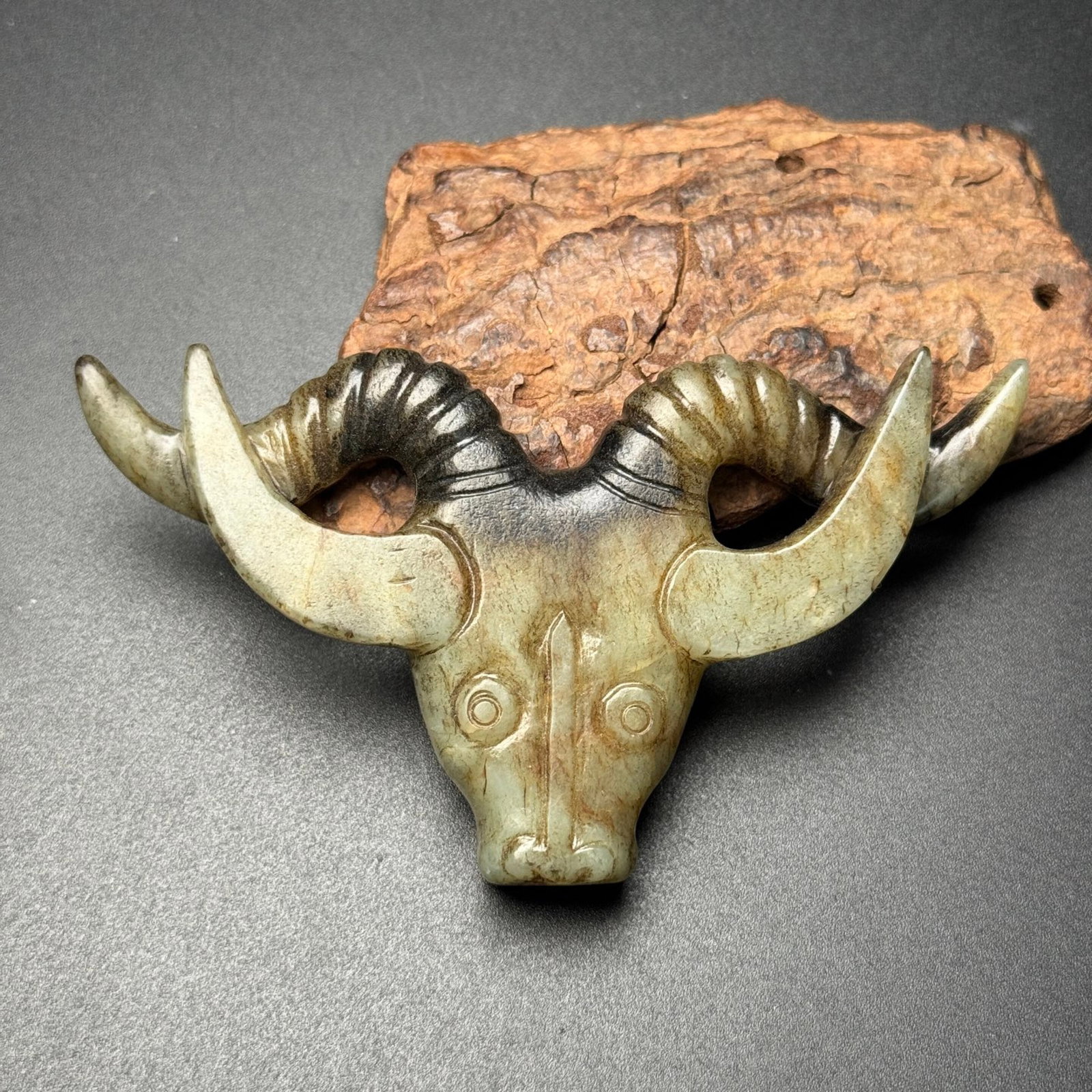 An Exquisite White Jade Buffalo-head Pendant: An Exquisite White Jade Buffalo-head Pendant,Qing Dynasty,China,Size:93mmx58mmx12mm,Weight:57g 白玉牛首挂件,中国清代