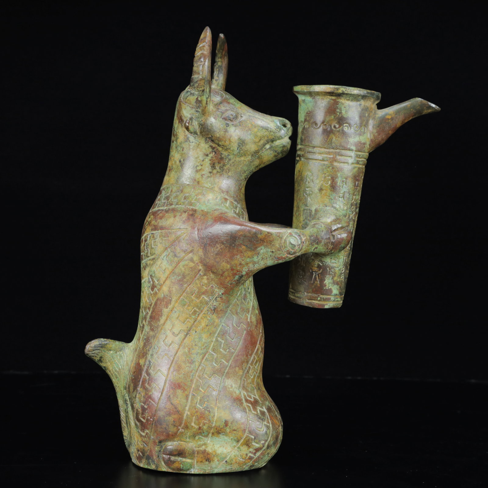 An Archaic Bronze Auspicious Beast Ornament,with Inscription: An Archaic Bronze Auspicious Beast Ornament,with Inscription,the Warring States Period in China,Size:9.4inx3.5inx13.4in,Weight:3400g 青铜瑞兽摆件,带铭&#