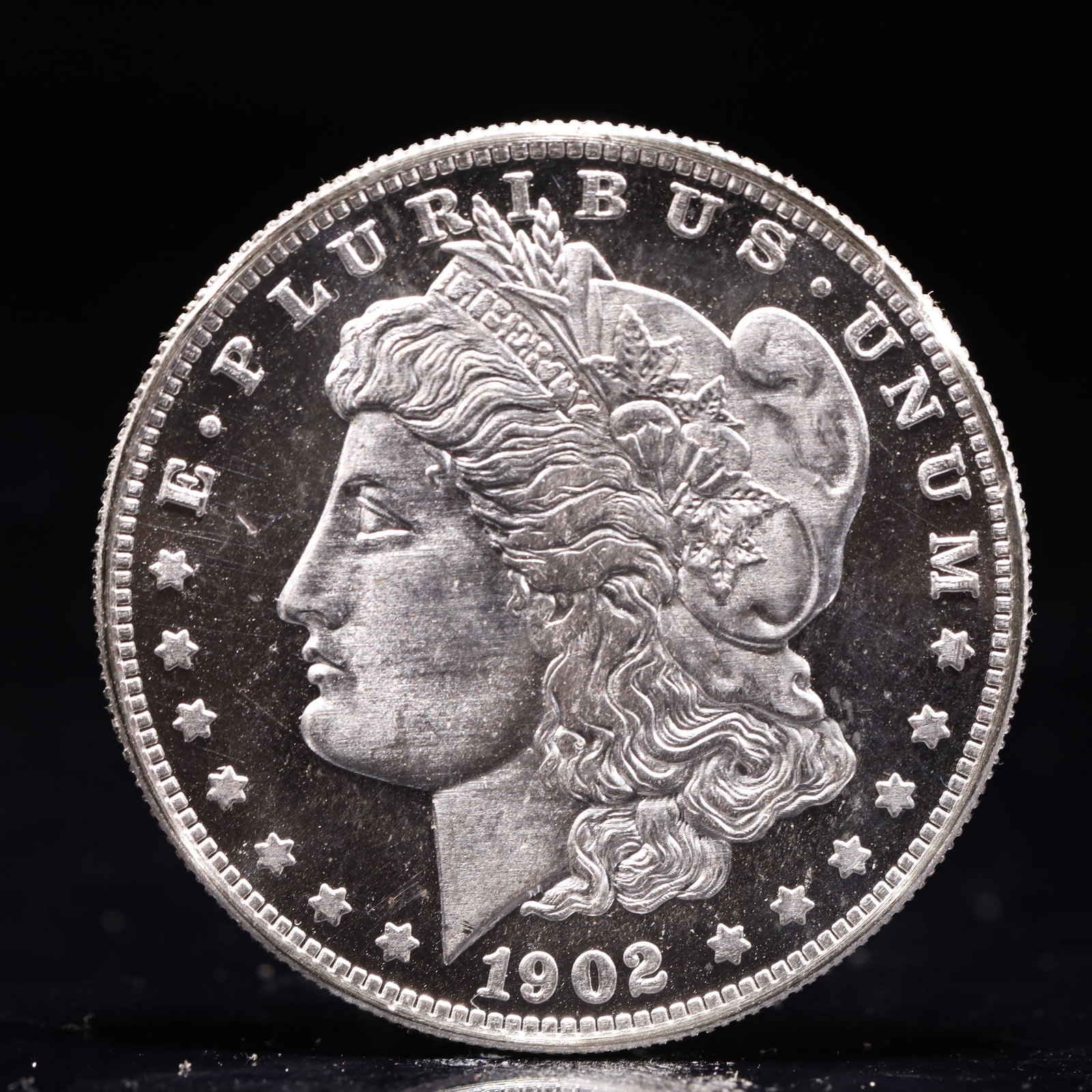 USA Morgan Dollar 1902 Coin: Obv: profile bust with date below and E PLURIBUS UNUM legend and stars around. Rev: eagle with In God we trust above within wreath with UNITED STATES OF AMERICA ONE DOLLAR legend. IN GOD WE TRUST / LI