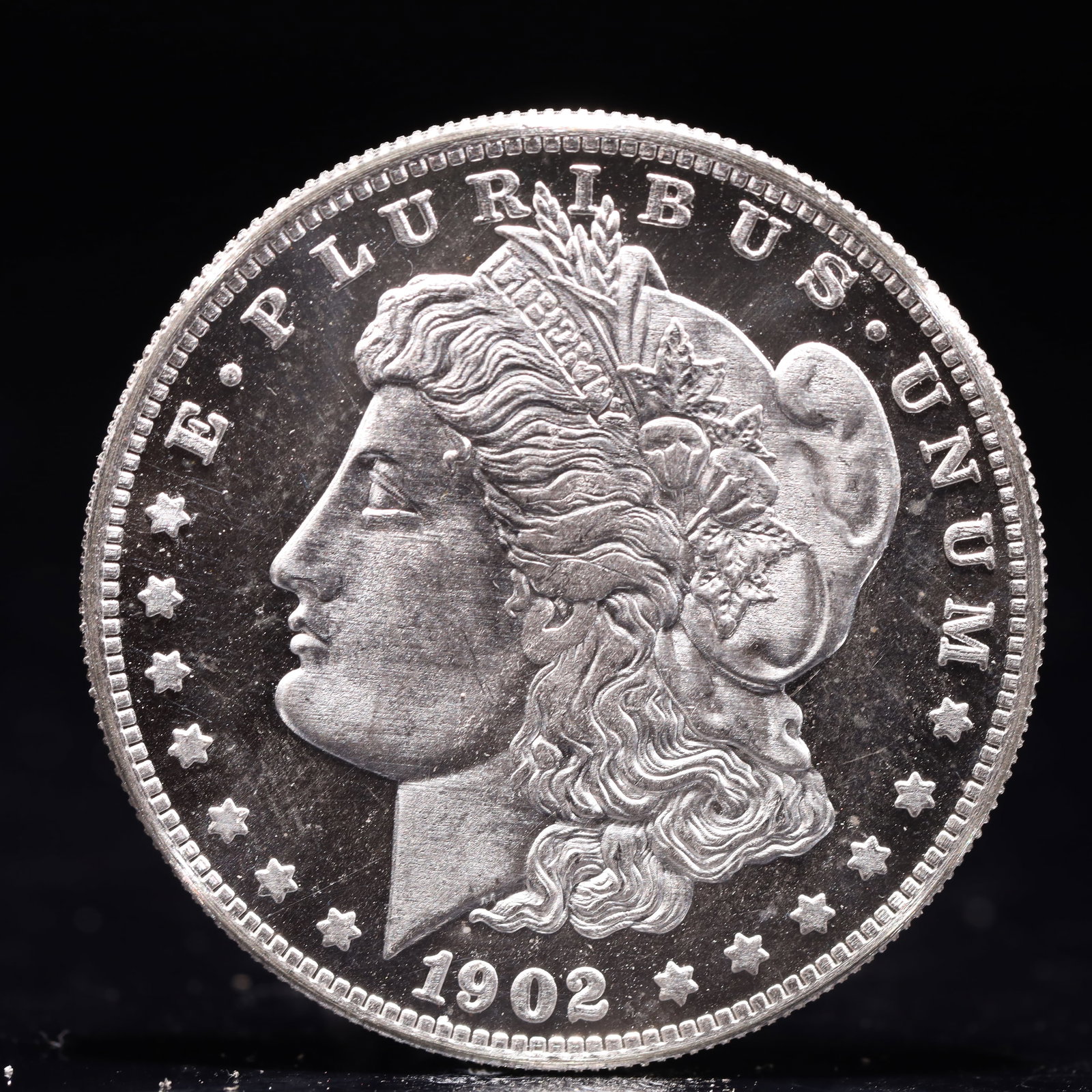 USA Morgan Dollar 1902 Coin: Obv: profile bust with date below and E PLURIBUS UNUM legend and stars around. Rev: eagle with In God we trust above within wreath with UNITED STATES OF AMERICA ONE DOLLAR legend. IN GOD WE TRUST / LI
