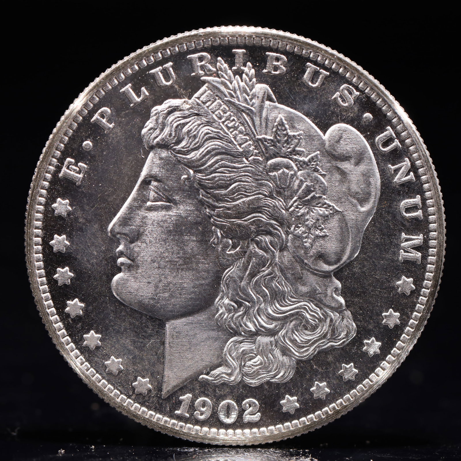 USA Morgan Dollar 1902 Coin: Obv: profile bust with date below and E PLURIBUS UNUM legend and stars around. Rev: eagle with In God we trust above within wreath with UNITED STATES OF AMERICA ONE DOLLAR legend. IN GOD WE TRUST / LI