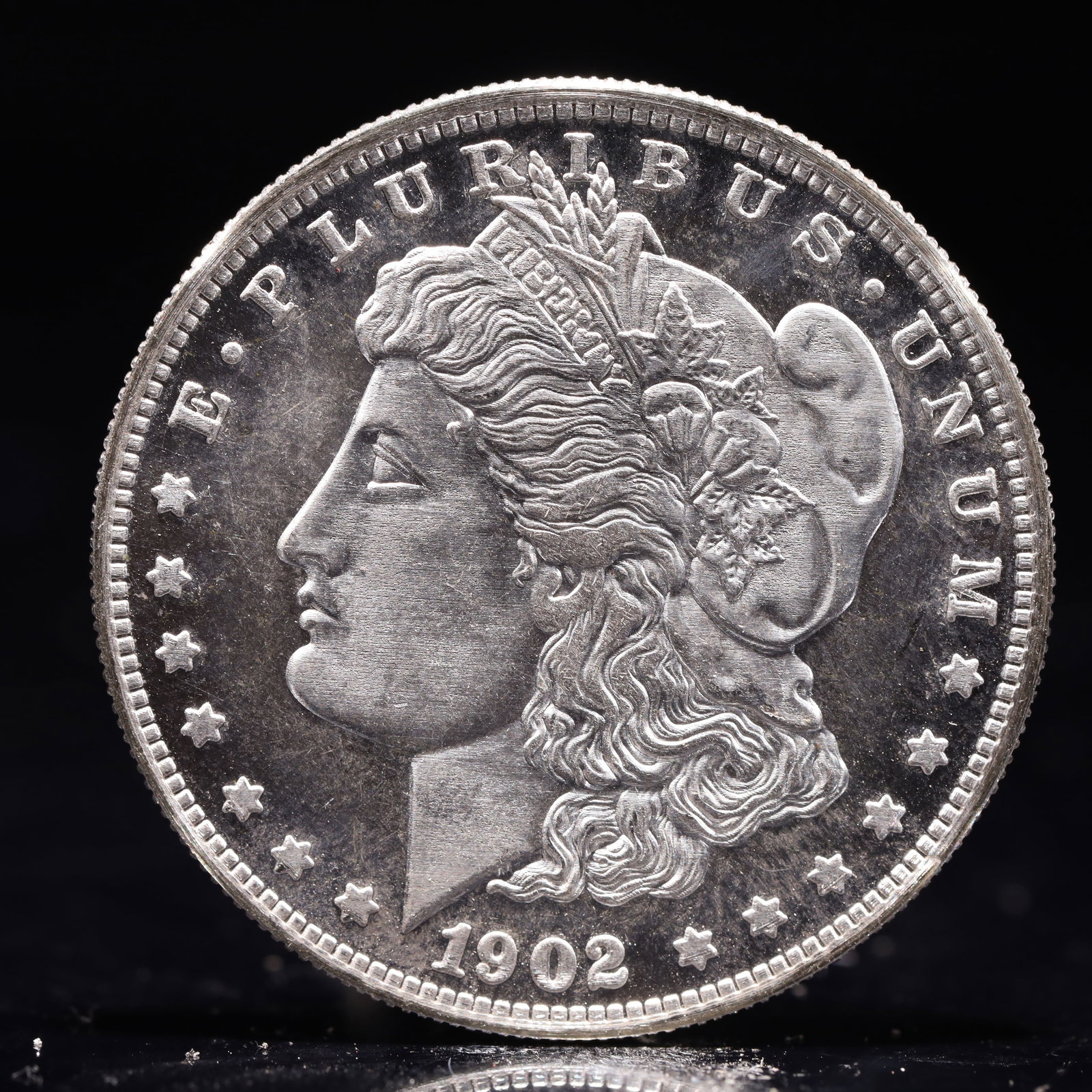 USA Morgan Dollar 1902 Coin: Obv: profile bust with date below and E PLURIBUS UNUM legend and stars around. Rev: eagle with In God we trust above within wreath with UNITED STATES OF AMERICA ONE DOLLAR legend. IN GOD WE TRUST / LI