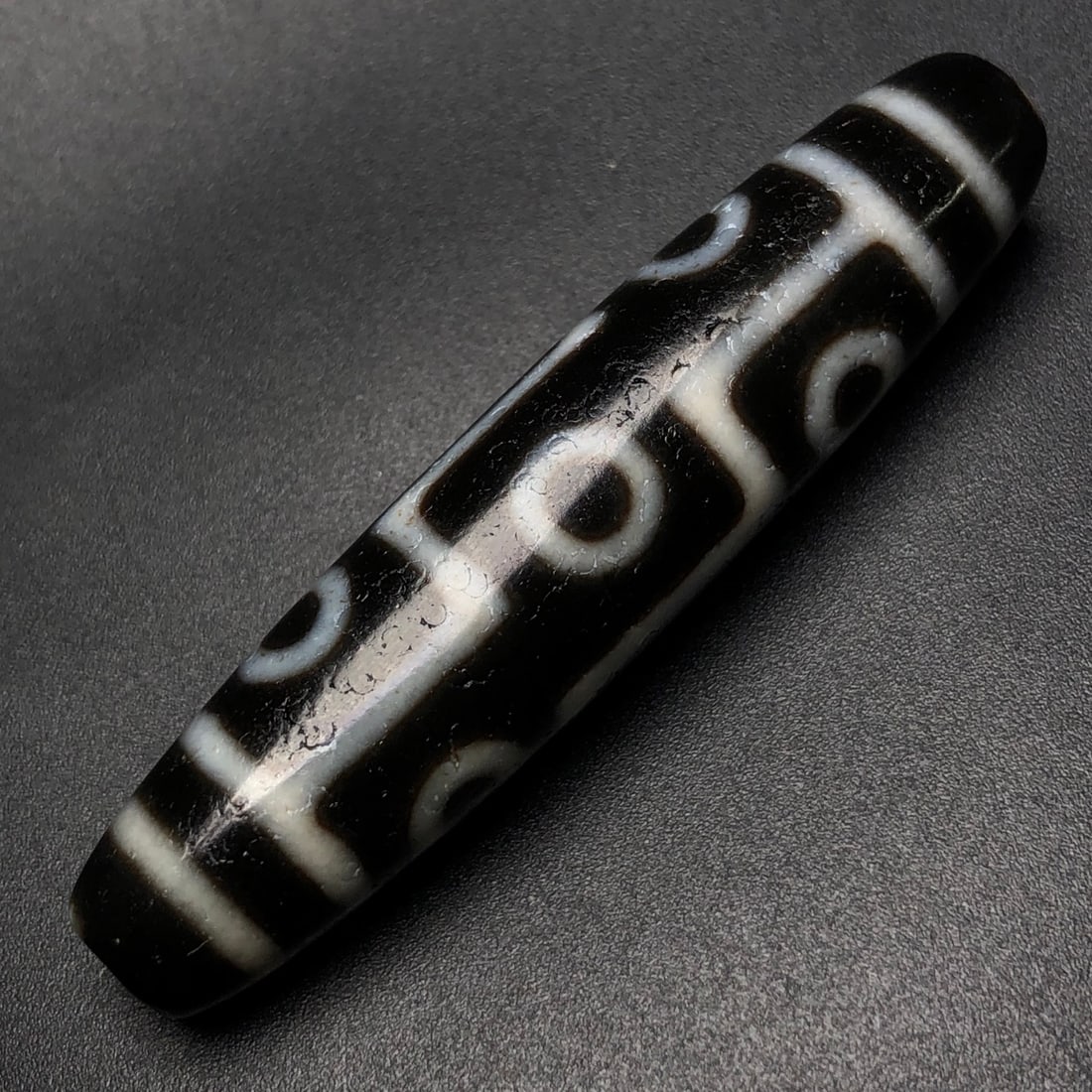 An Exquisite Nine Eyes Dzi Bead Pendant: An Exquisite Nine Eyes Dzi Bead Pendant,Size:59mmx13mm,Weight:15.6g 九眼天珠挂件