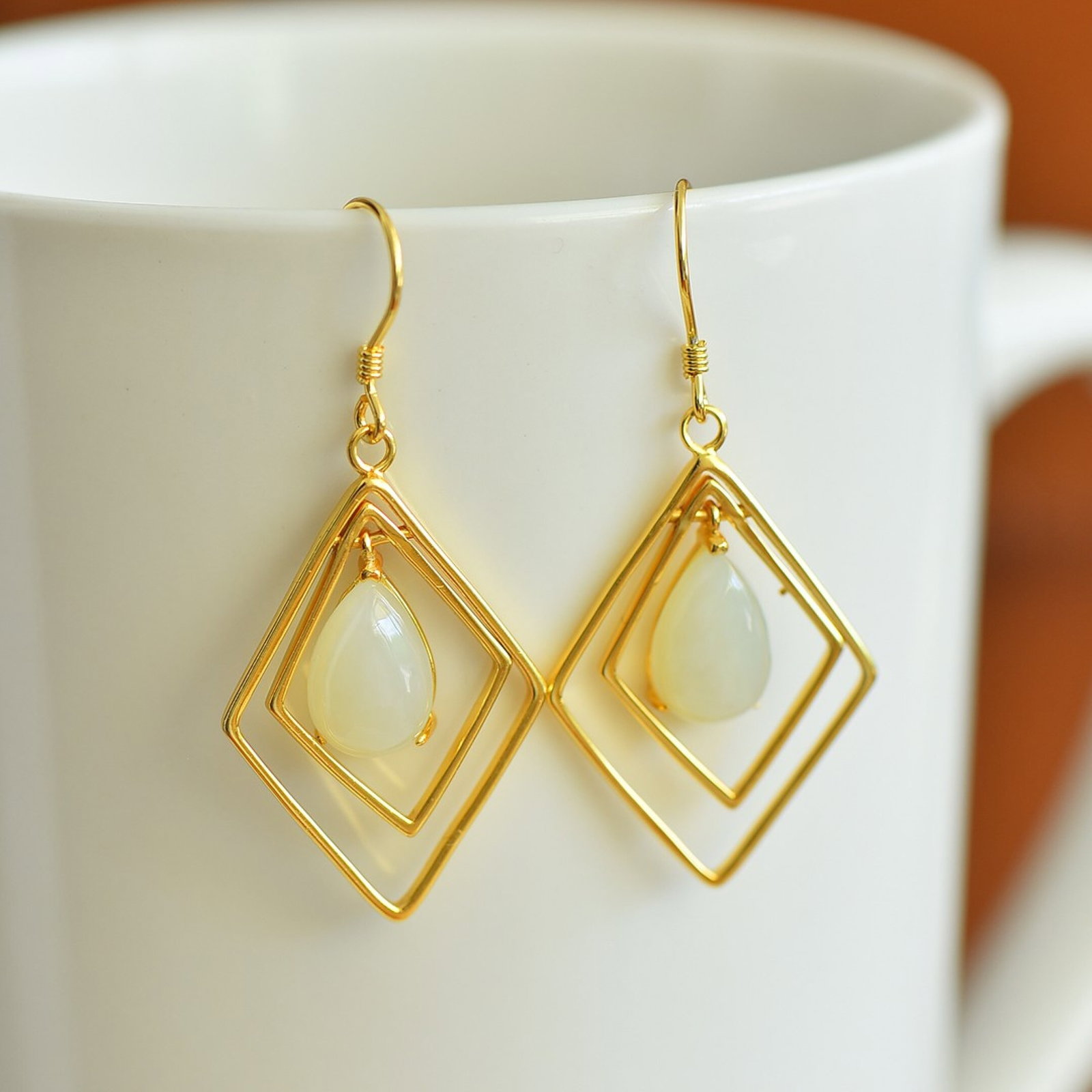 A Pair of Exquisite Sterling Silver-Gold Plated Inlaid White Jade Earrings: A Pair of Exquisite Sterling Silver-Gold Plated Inlaid White Jade Earrings,Size:8mmx12mm 一对纯银镀金镶白玉耳环
