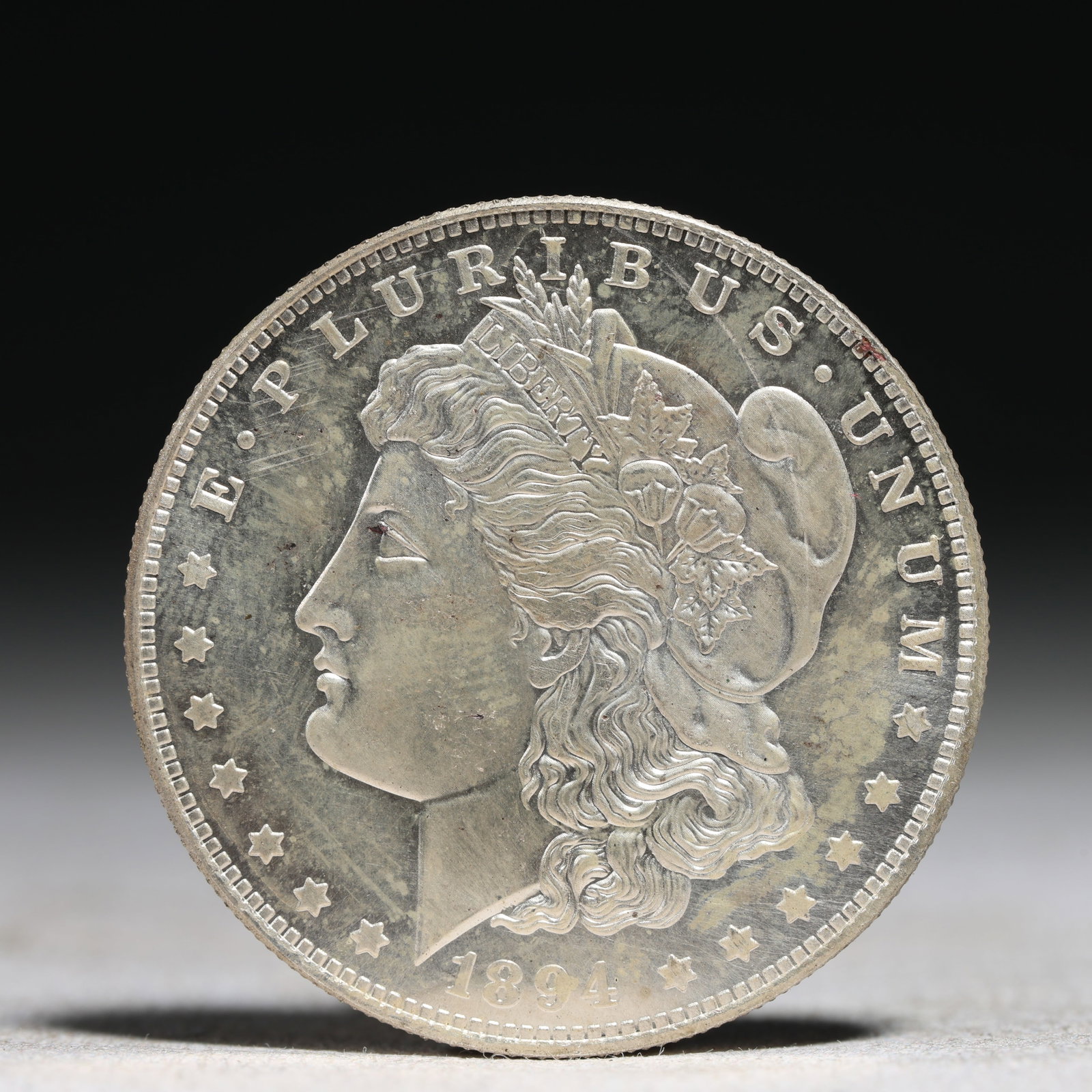 USA Morgan Dollar 1894 Coin: Obv: profile bust with date below and E PLURIBUS UNUM legend and stars around. Rev: eagle with In God we trust above within wreath with UNITED STATES OF AMERICA ONE DOLLAR legend. IN GOD WE TRUST / LI