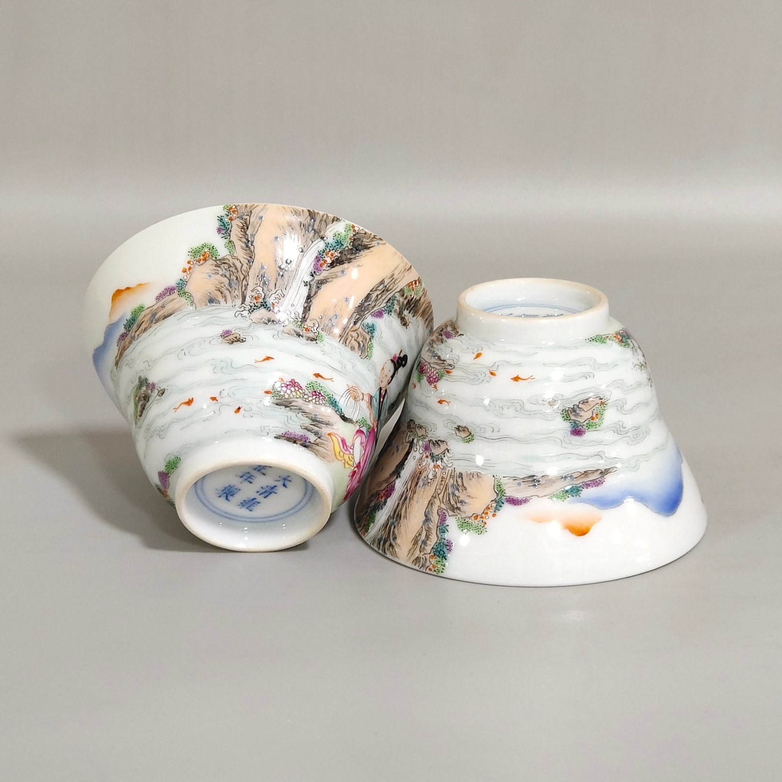 A Pair of Exquisite Famille-Rose Landscape and Figure Pattern Cups: A Pair of Exquisite Famille-Rose Landscape and Figure Pattern Cups,Qing Dynasty,China,Yongzheng Six-character Mark,Size:1.8inx2.7in 一对粉彩山水人物 