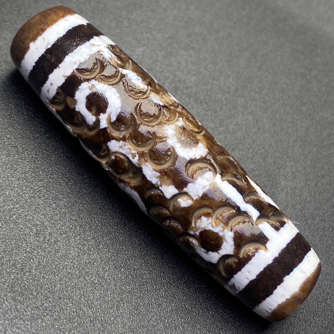 An Exquisite Nine Eyes Dzi Bead Pendant: An Exquisite Nine Eyes Dzi Bead Pendant,Size:56mmx15mm,Weight:20g 九眼天珠挂件