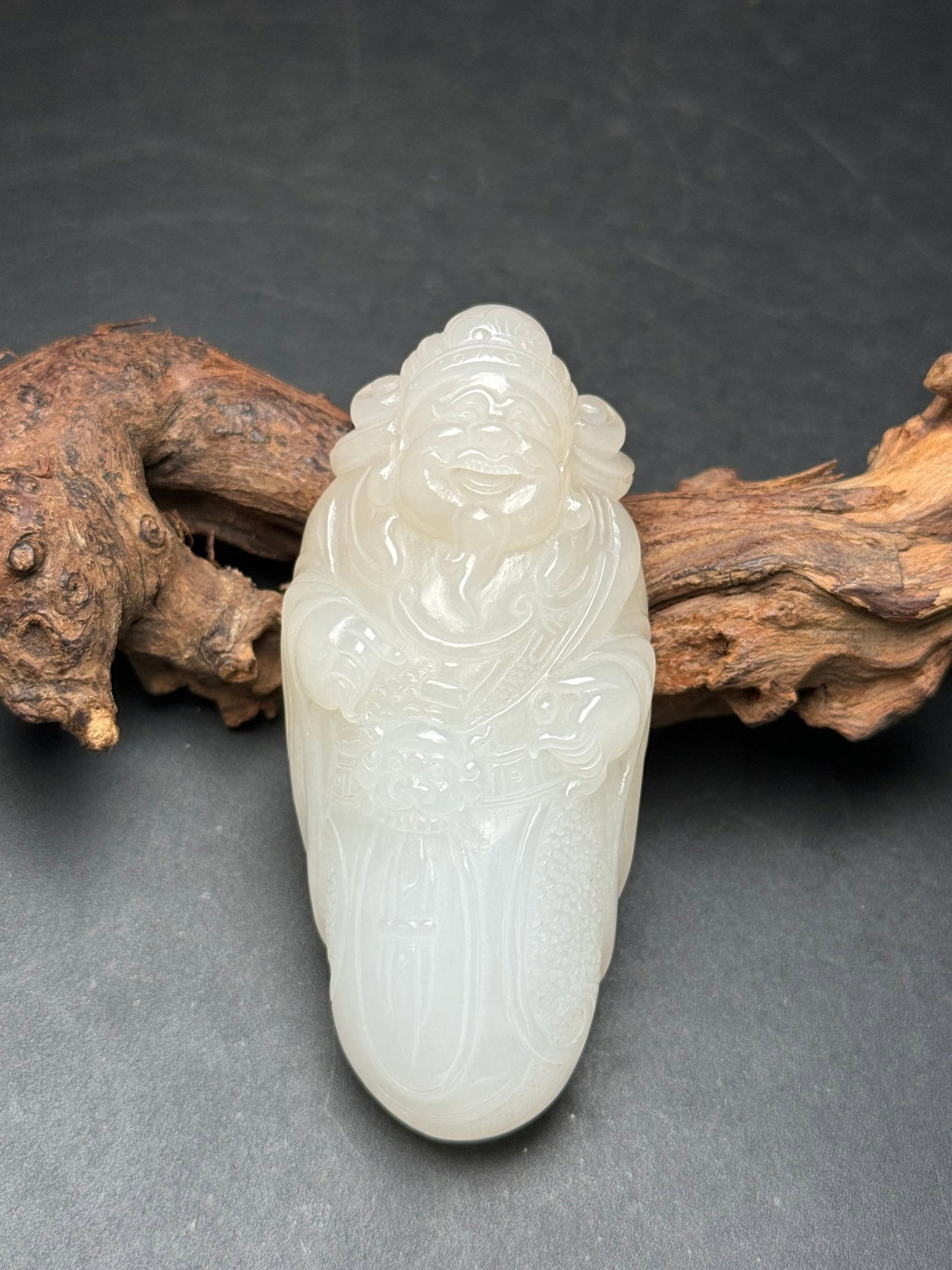 An Exquisite White Jade Statue of Mammon Hand Piece: An Exquisite White Jade Statue of Mammon Hand Piece,Qing Dynasty,China,Size:77mmx35mmx24mm,Weight:90g 白玉财神像手把件,中国清代