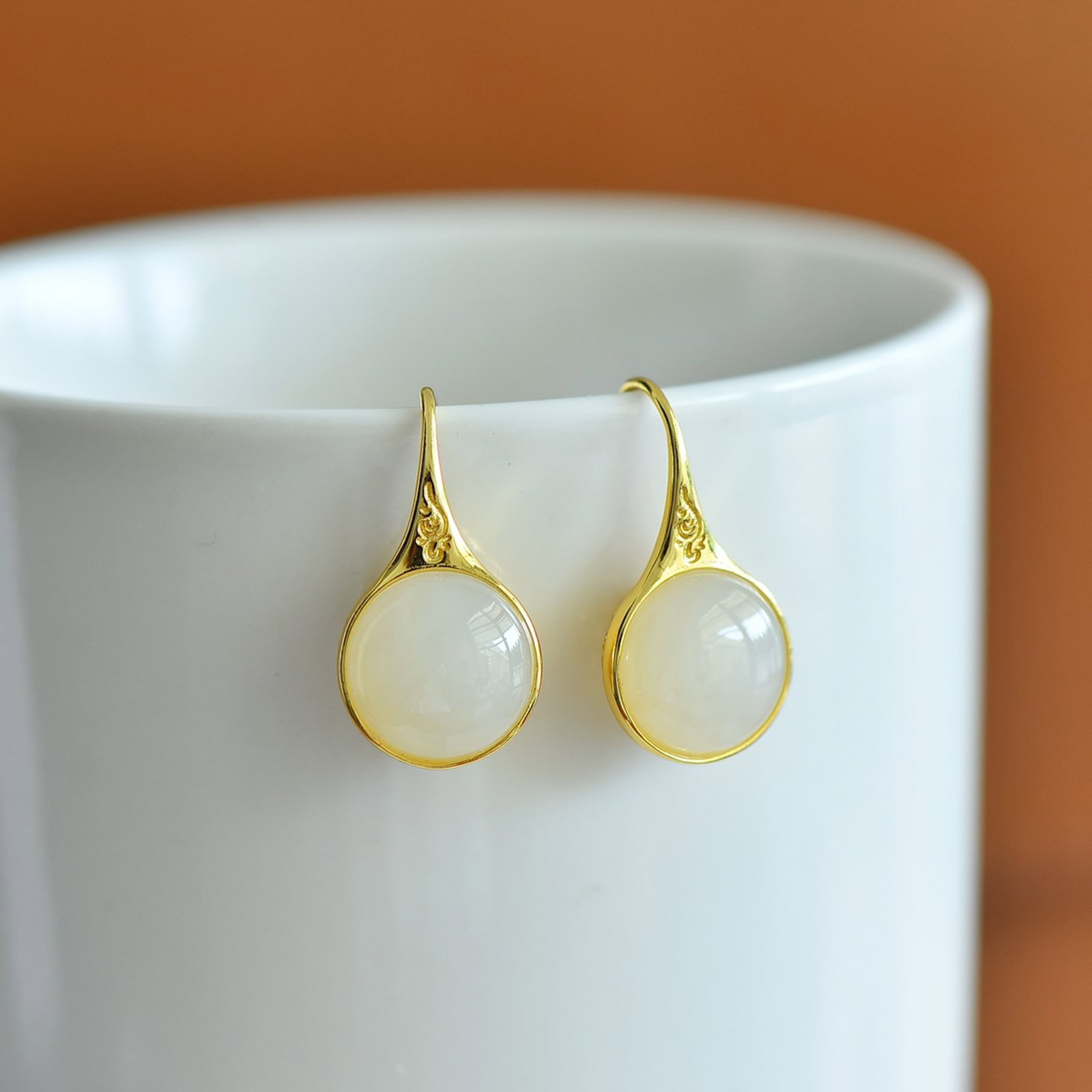 A Pair of Exquisite Sterling Silver-Gold Plated Inlaid White Jade Earrings: A Pair of Sterling Silver-Gold Plated Inlaid White Jade Earrings , Size :12mmx12mms 一对纯银镀金镶白玉耳环,尺寸:12mmx12mm