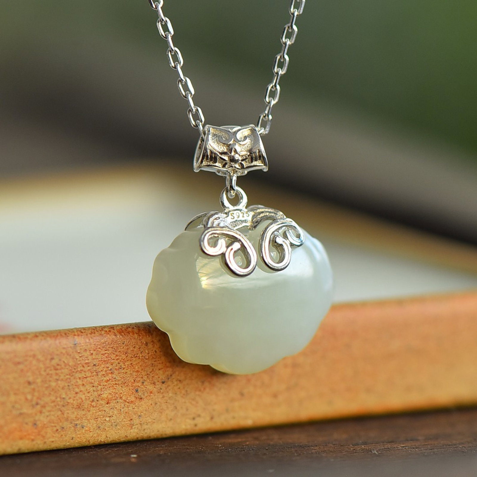 An Exquisite Sterling Silver Inlaid White Jade Pendant: An Exquisite Sterling Silver Inlaid White Jade Pendant,Size:13mmx18mm 纯银镶白玉吊坠