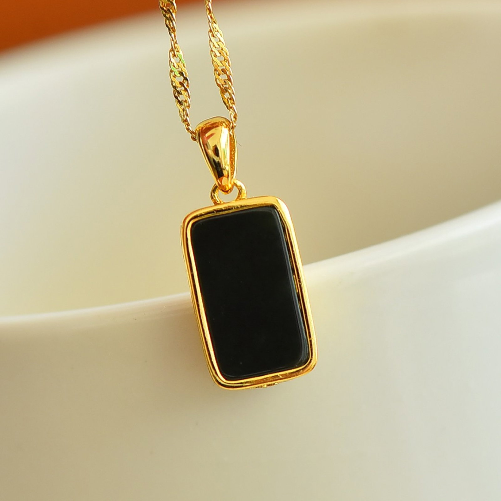 An Exquisite Sterling Silver-Gold Plated Inlaid Black Jade Pendant: Sterling Silver-Gold Plated Inlaid Black Jade Pendant , Size :7mmx13mm 纯银镀金镶黑玉吊坠,尺寸:7mmx13mm