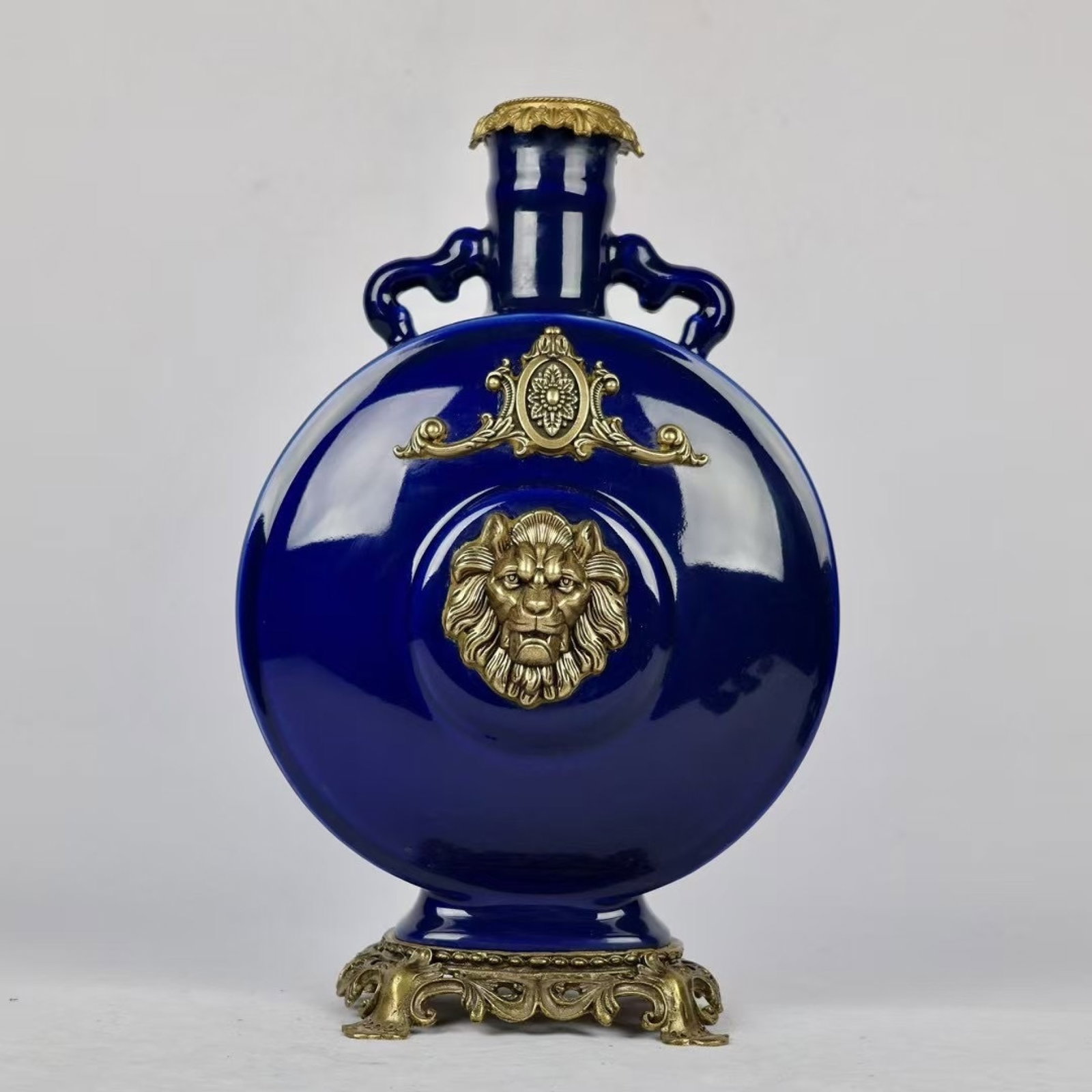 A Rare Sapphire Blue Glazed Inlaid Bronze Lion Pattern Double-Ears Vase: A Rare Sapphire Blue Glazed Inlaid Bronze Lion Pattern Double-Ears Vase,Qing Dynasty,China,Kangxi Six-Character Mark,Size:15.4inx9.4in 宝石蓝釉嵌铜狮子&