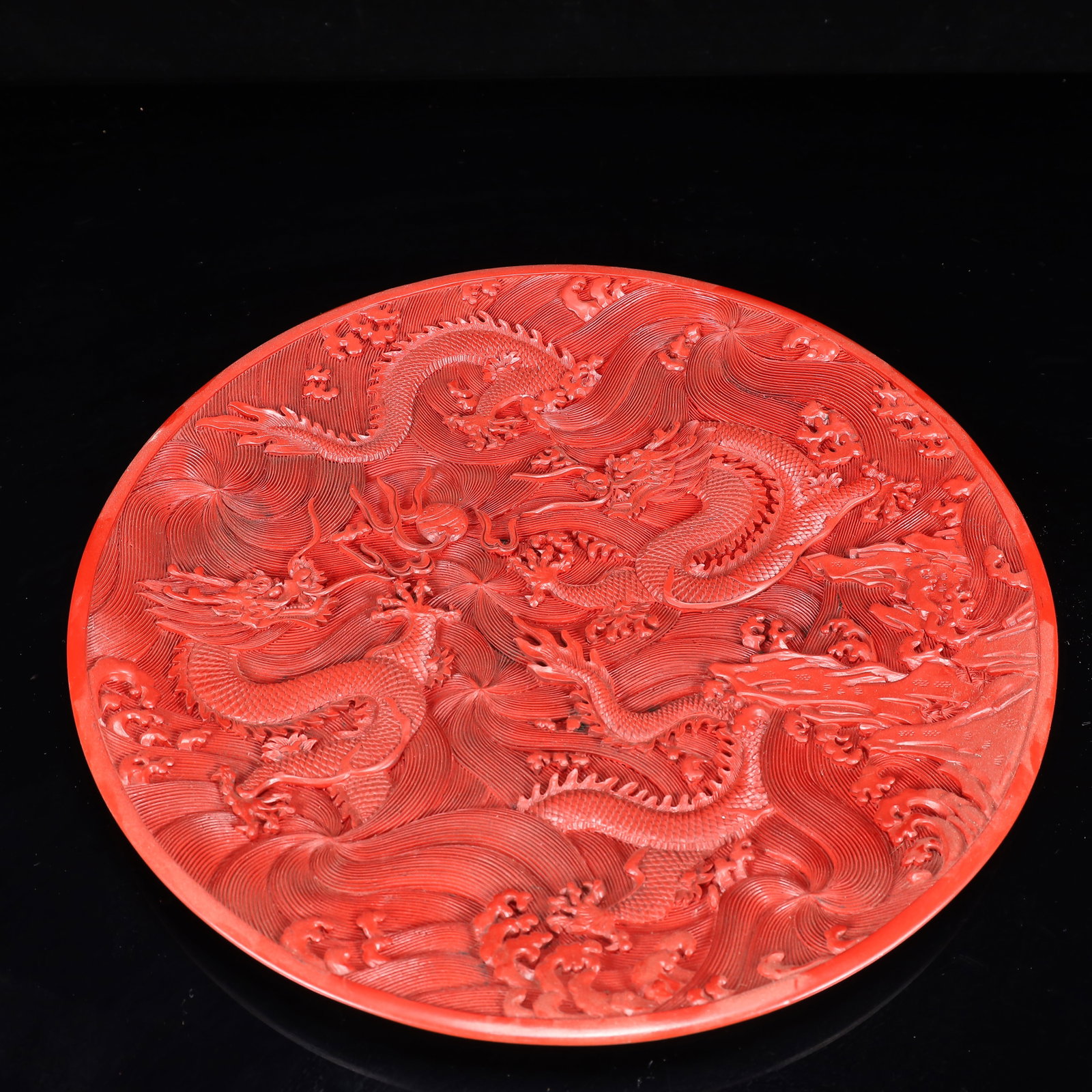 A Rare Carved Red Lacquer Dragon Pattern Plate: A Rare Carved Red Lacquer Dragon Pattern Plate,Qing Dynasty, China,Qianlong Four-character Mark,Size:14.6inx1.2in,Weight:1550g 剔红漆器龙纹盘,中国