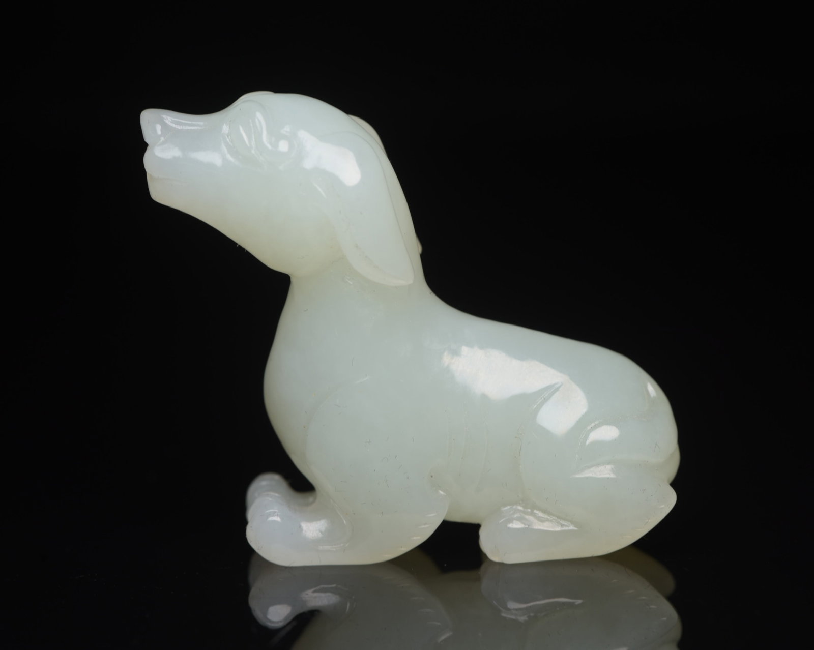 An Exquisite White Jade Dog Ornament: An Exquisite White Jade Dog Ornament,Qing Dynasty,China,Size:2inx1.7inx0.6in,Weight:38g 白玉犬摆件,中国清代