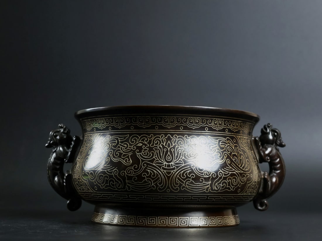 An Exquisite Bronze Inlaid Silver Flower and Phoenix Pattern Dragon-Ears Censer: An Exquisite Bronze Inlaid Silver Flower and Phoenix Pattern Dragon-Ears Censer,Qing Dynasty, China, With Mark,Size:3.4inx6.1in,Weight:2700g 铜嵌银花卉凤纹