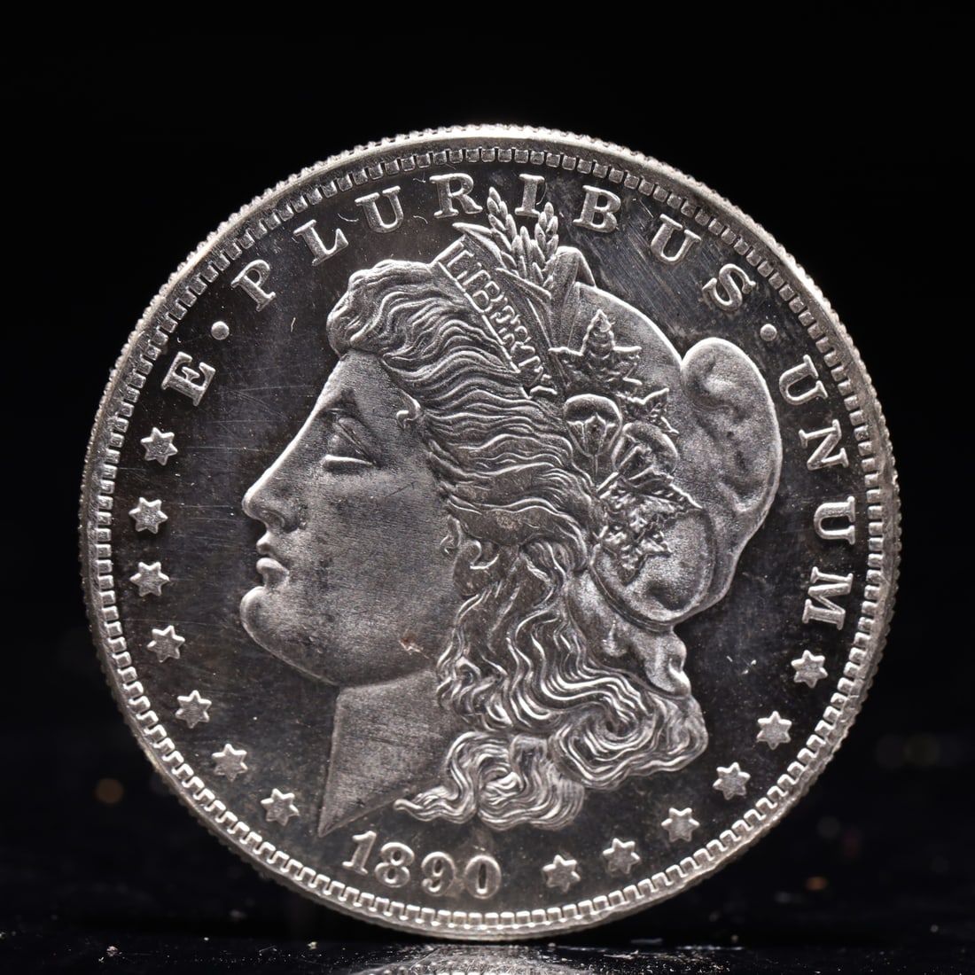 USA Morgan Dollar 1890 Coin: Obv: profile bust with date below and E PLURIBUS UNUM legend and stars around. Rev: eagle with In God we trust above within wreath with UNITED STATES OF AMERICA ONE DOLLAR legend. IN GOD WE TRUST / LI