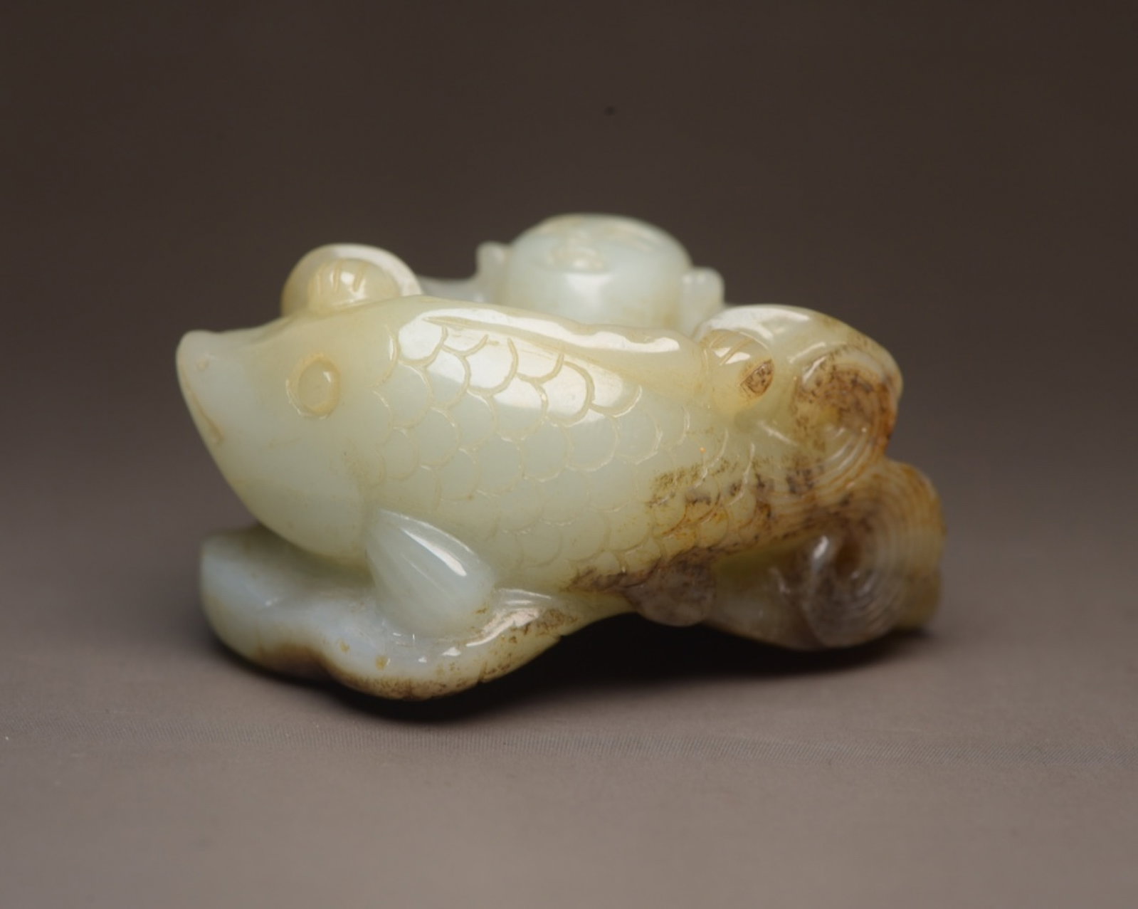 An Exquisite White Jade Figure and Fish Ornament: An Exquisite White Jade Figure and Fish Ornament,Qing Dynasty,China,Size:2.1inx1.7inx1.1in,Weight:72g 白玉人物鱼摆件,中国清代