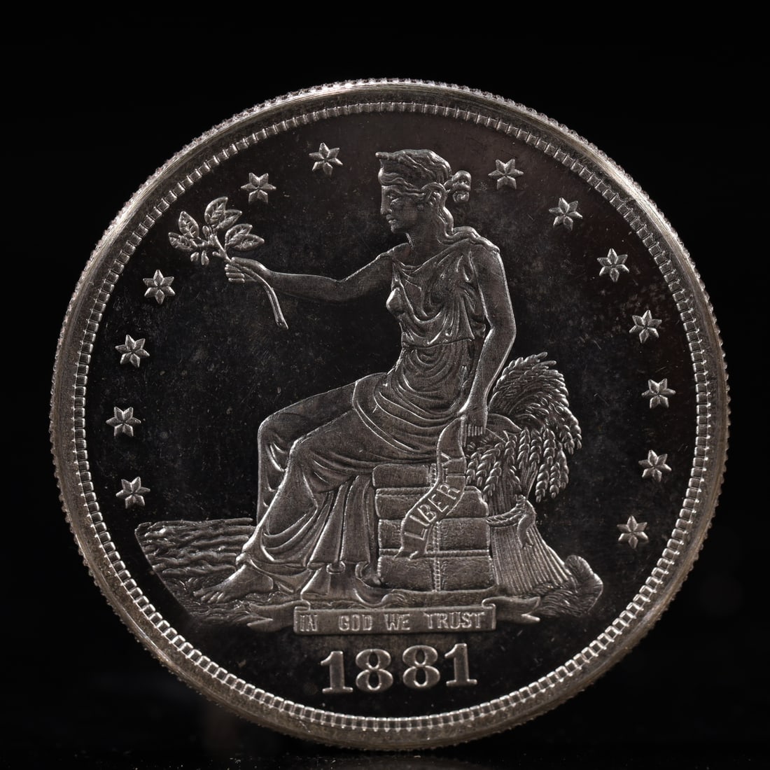 USA Trade Dollar 1881 Coin: American coin. Obverse: Liberty seated on a pedestal facing the sea to the left holding olive branches surrounded by 13 stars. IN GOD WE TRUST / LIBERTY / 1881. Reverse: An eagle holding branches with