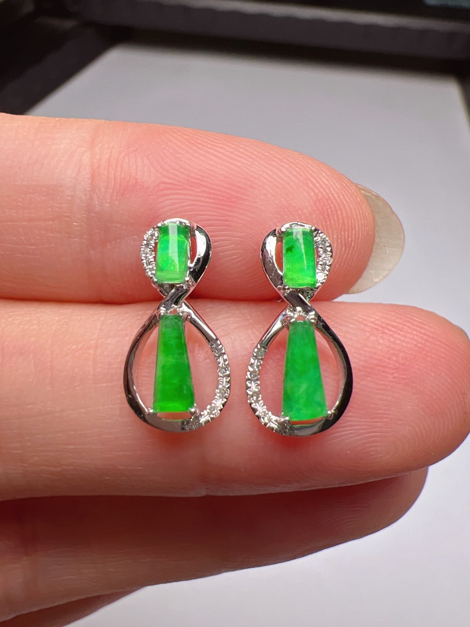 A Pair of Exquisite 18k Gold Diamond Inlaid Jadeite Earrings: A Pair of Exquisite 18k Gold Diamond Inlaid Jadeite Earrings,Size(Loose Stone):6.3mmx3.2mm 一对18k金钻镶嵌翡翠耳钉