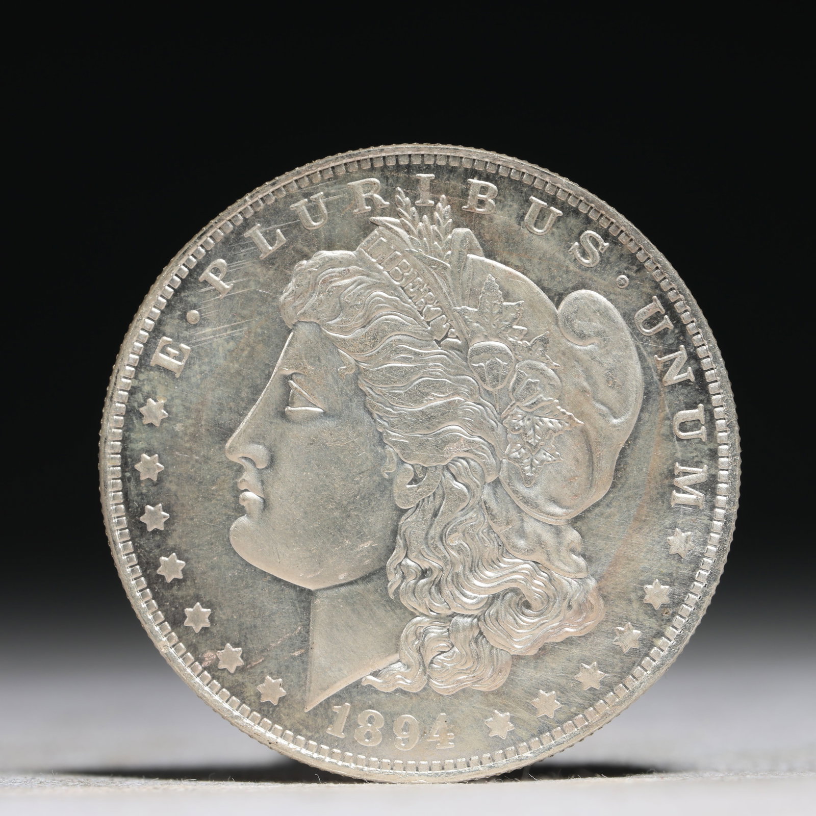 USA Morgan Dollar 1894 Coin: Obv: profile bust with date below and E PLURIBUS UNUM legend and stars around. Rev: eagle with In God we trust above within wreath with UNITED STATES OF AMERICA ONE DOLLAR legend. IN GOD WE TRUST / LI