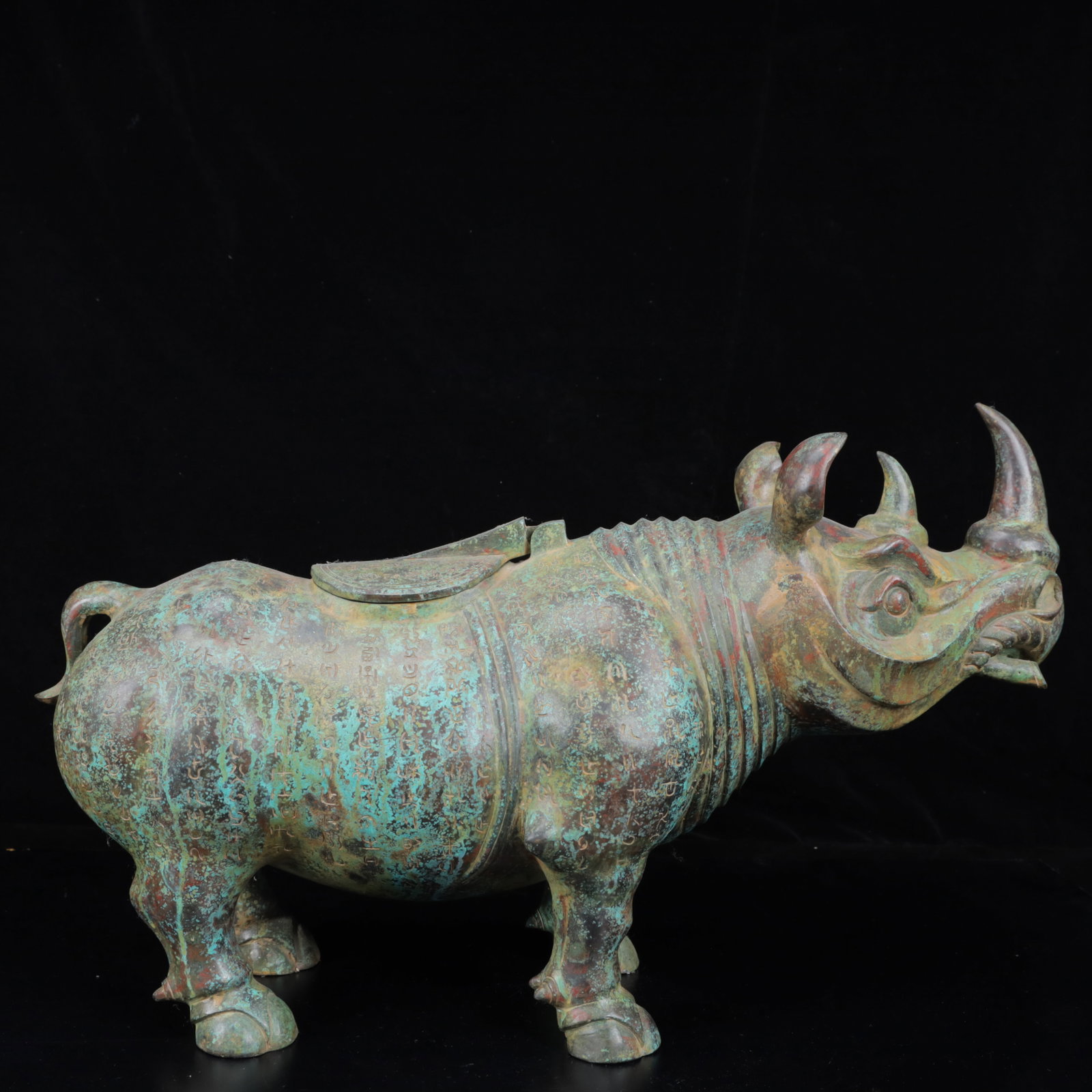 An Archaic Bronze Rhinoceros Zun,With Inscription: An Archaic Bronze Rhinoceros Zun,With Inscription,The Warring States period in China,Size:21.7inx6.3inx12.6in,Weight:6450g