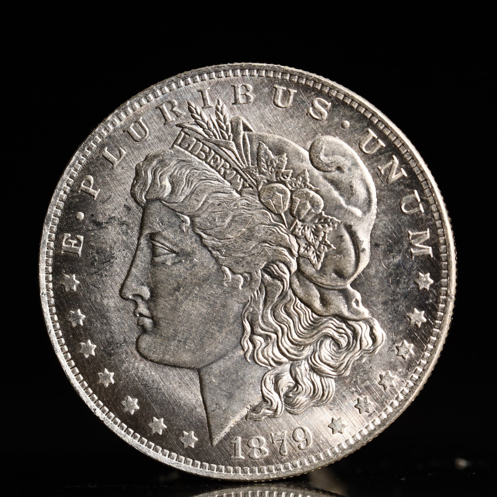 USA Morgan Dollar 1879 Coin: Obv: profile bust with date below and E PLURIBUS UNUM legend and stars around. Rev: eagle with In God we trust above within wreath with UNITED STATES OF AMERICA ONE DOLLAR legend. IN GOD WE TRUST / LI