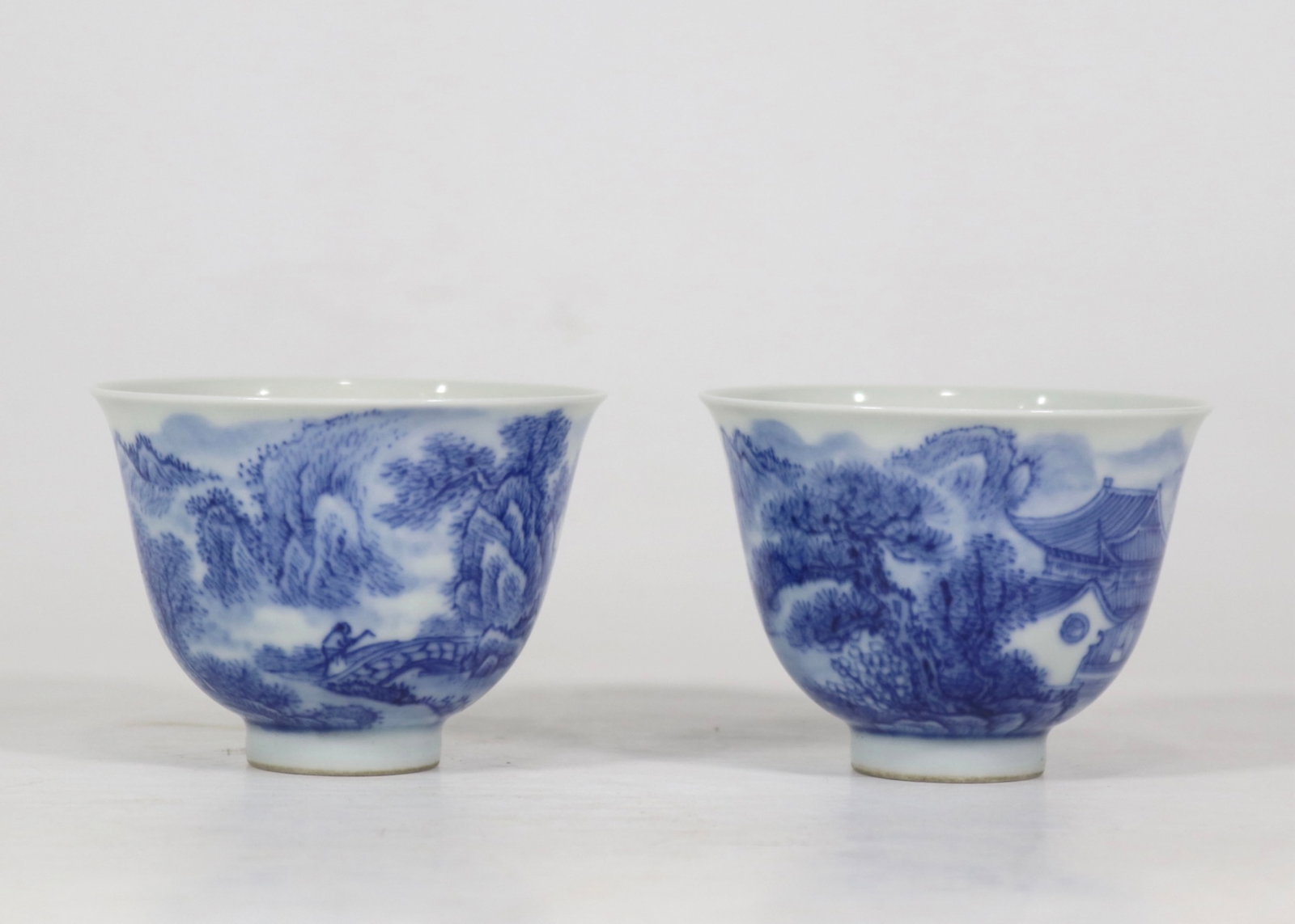 A Pair of Exquisite Blue and White Landscape and Figure Pattern Cups: A Pair of Exquisite Blue and White Landscape and Figure Pattern Cups,Qing Dynasty,China,Yongzheng Six-character Mark,Size:2.2inx3ins