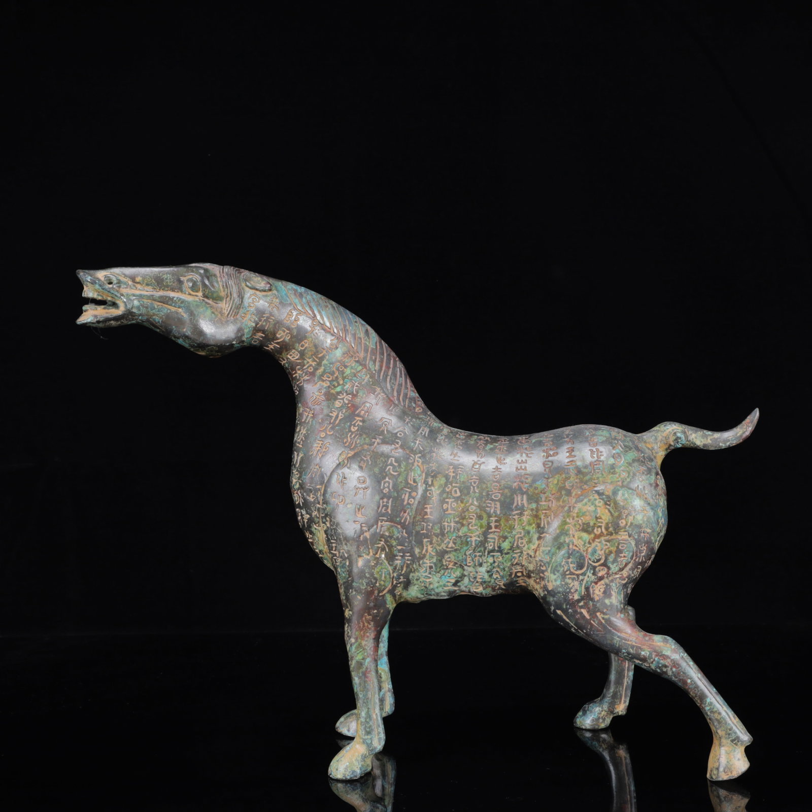 An Archaic Bronze Inscription Horse Ornament: An Archaic Bronze Inscription Horse Ornament,the Warring States Period in China,Size:14.2inx3.9inx11in,Weight:2250g 青铜铭文马摆件,中国战