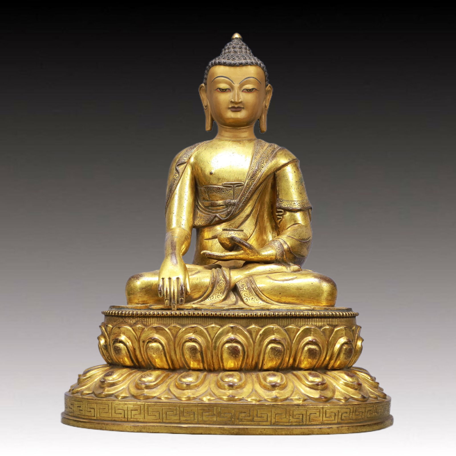 A Solemn Gilt Bronze Statue of Sakyamuni: A Solemn Gilt Bronze Statue of Sakyamuni,Ming Dynasty, China,Size:14inx11.4inx17.7inWeight:15800g 铜鎏金释迦牟尼像,中国明代
