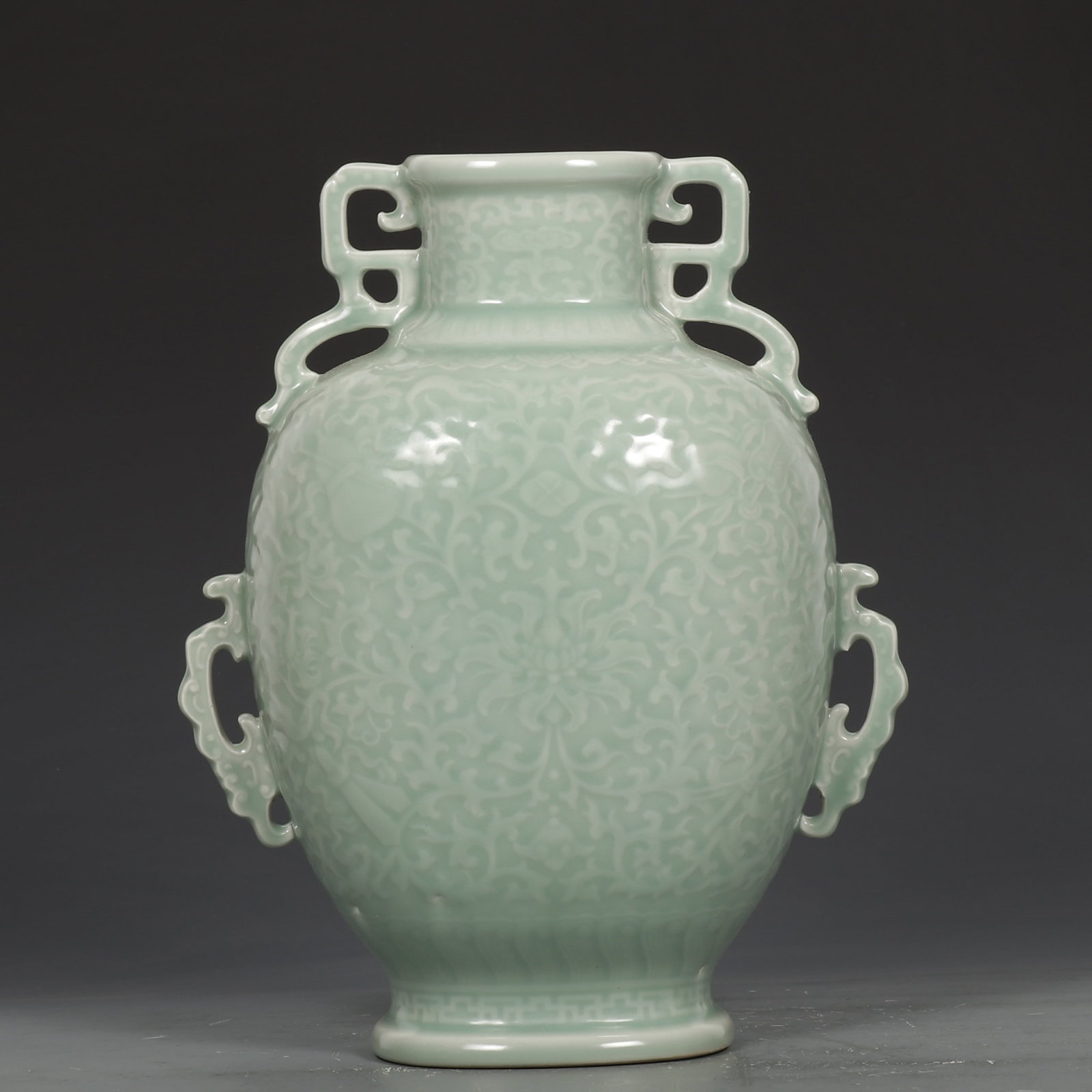 An Exquisite Celadon Glazed Lotus Pattern Double-Ears Vase: An Exquisite Celadon Glazed Lotus Pattern Double-Ears Vase,Qing Dynasty,China ,Qianlong Six-character Mark,Size:11.2inx8.7in 青釉缠枝莲纹双耳瓶,&#
