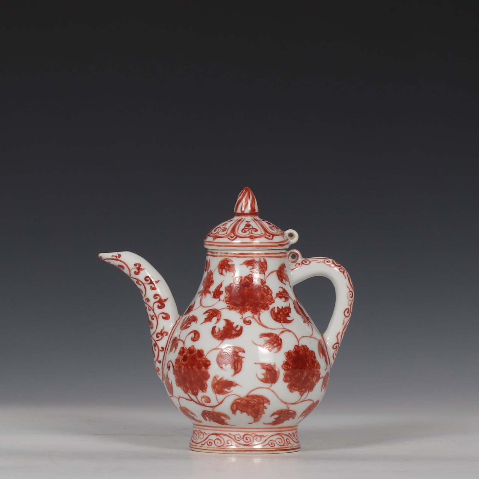 An Exquisite Iron-Red Lotus Pattern Ewer: An Exquisite Iron-Red Lotus Pattern Ewer,Ming Dynasty,China ,Xuande Six-character Mark,Size:5.5inx5.3in 矾红缠枝莲纹执壶,中国明代