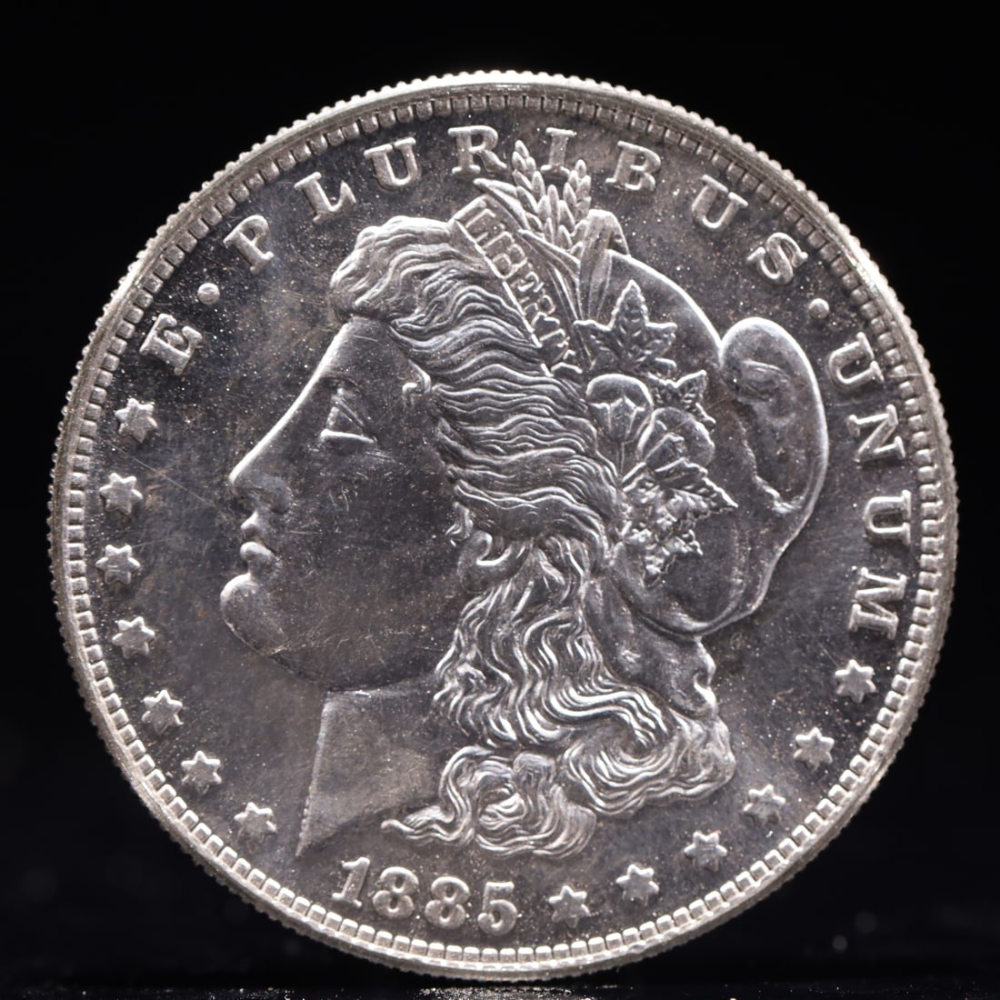 USA Morgan Dollar 1885 Coin: Obv: profile bust with date below and E PLURIBUS UNUM legend and stars around. Rev: eagle with In God we trust above within wreath with UNITED STATES OF AMERICA ONE DOLLAR legend. IN GOD WE TRUST /