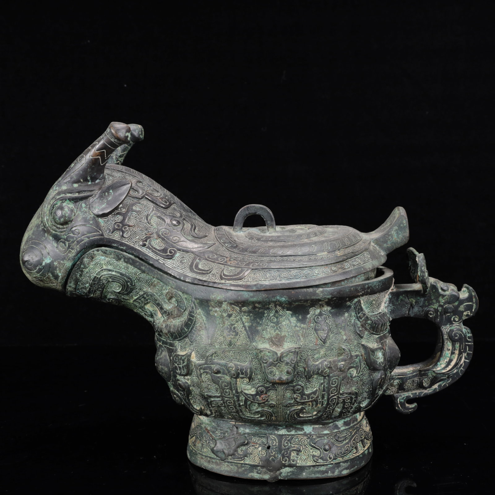 An Archaic Bronze Auspicious Beast Cup: An Archaic Bronze Auspicious Beast Cup,The Warring States period in China,Size:13inx6.3inx9.8in,Weight:2750g 青铜瑞兽觥,中国战国时期